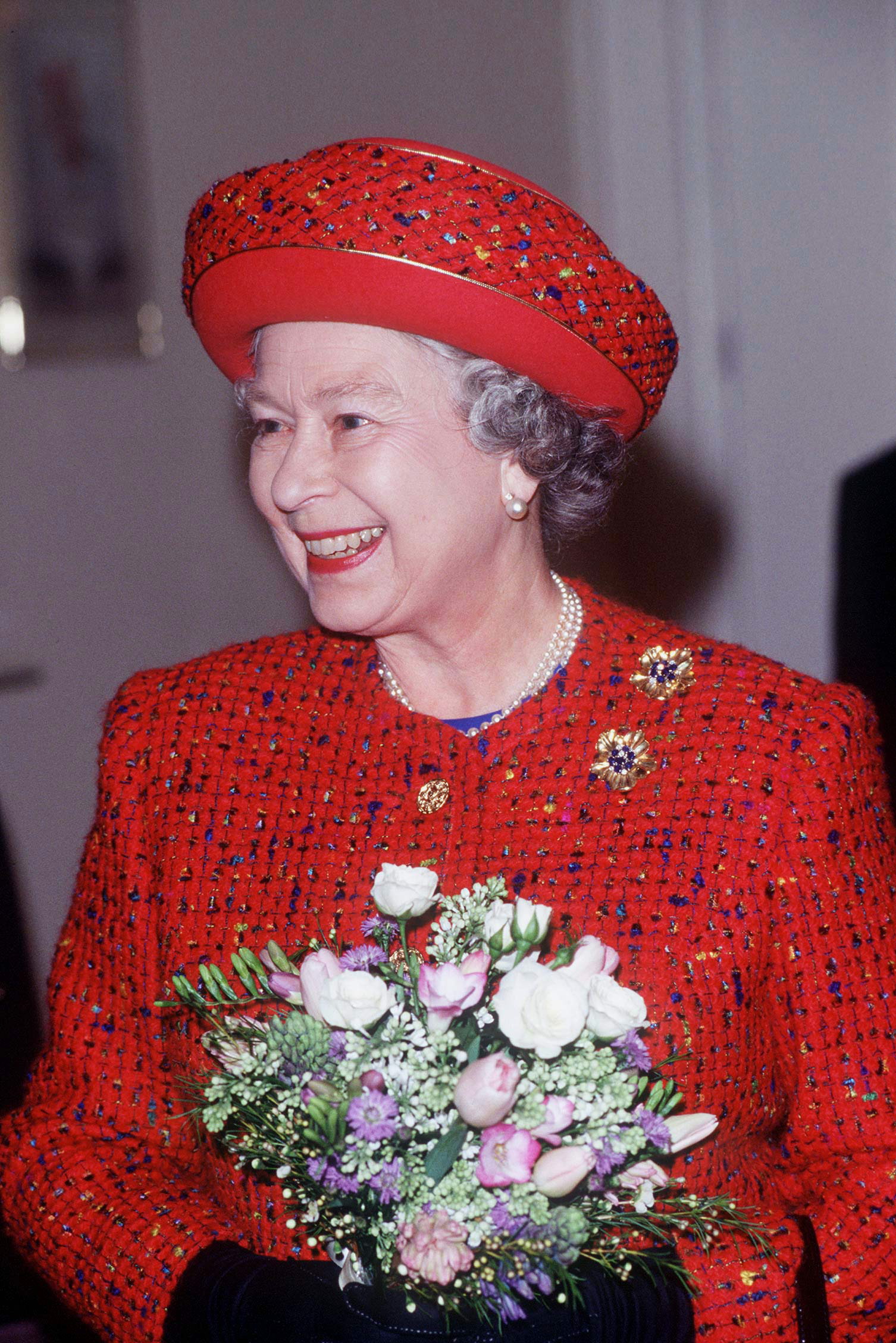Queen Elizabeth II visiting charitable homes for the elderly in London, England on February 22, 1996 | Source: Getty Images