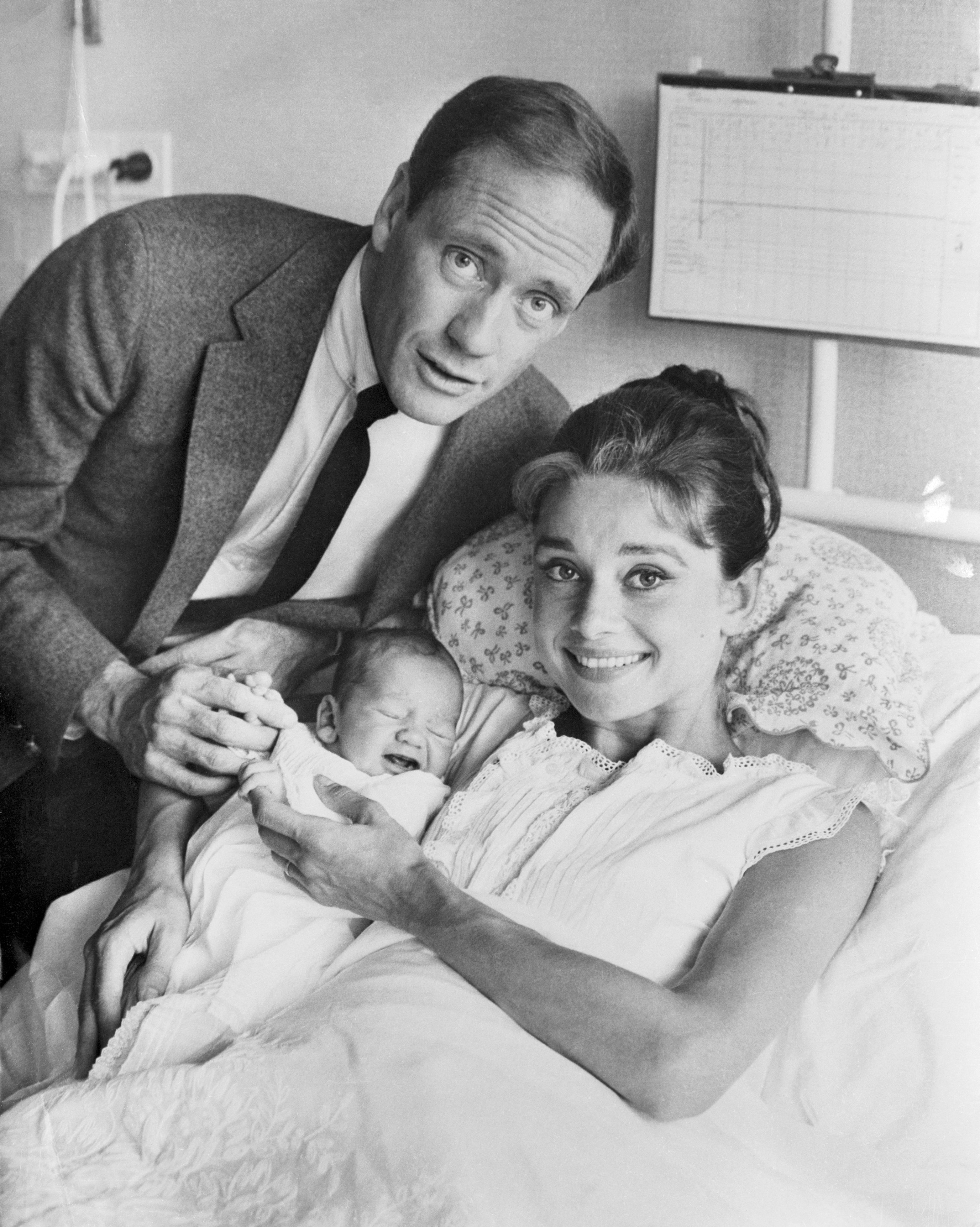 Film actress Audrey Hepburn and her husband, actor Mel Ferrer, proudly show off their baby son, Sean, here July 19th. The nine pound youngster was born July 17th. He is the actress' first child. | Source: Getty Images