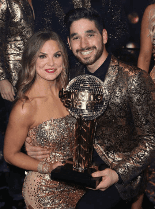 Hannah Brown and Alan Bersten backstage, holding the mirror ball after their win, at "Dancing with the Stars" Season 28 Finale, on November 25, 2019, in Los Angeles, California | Source: David Livingston/Getty Images