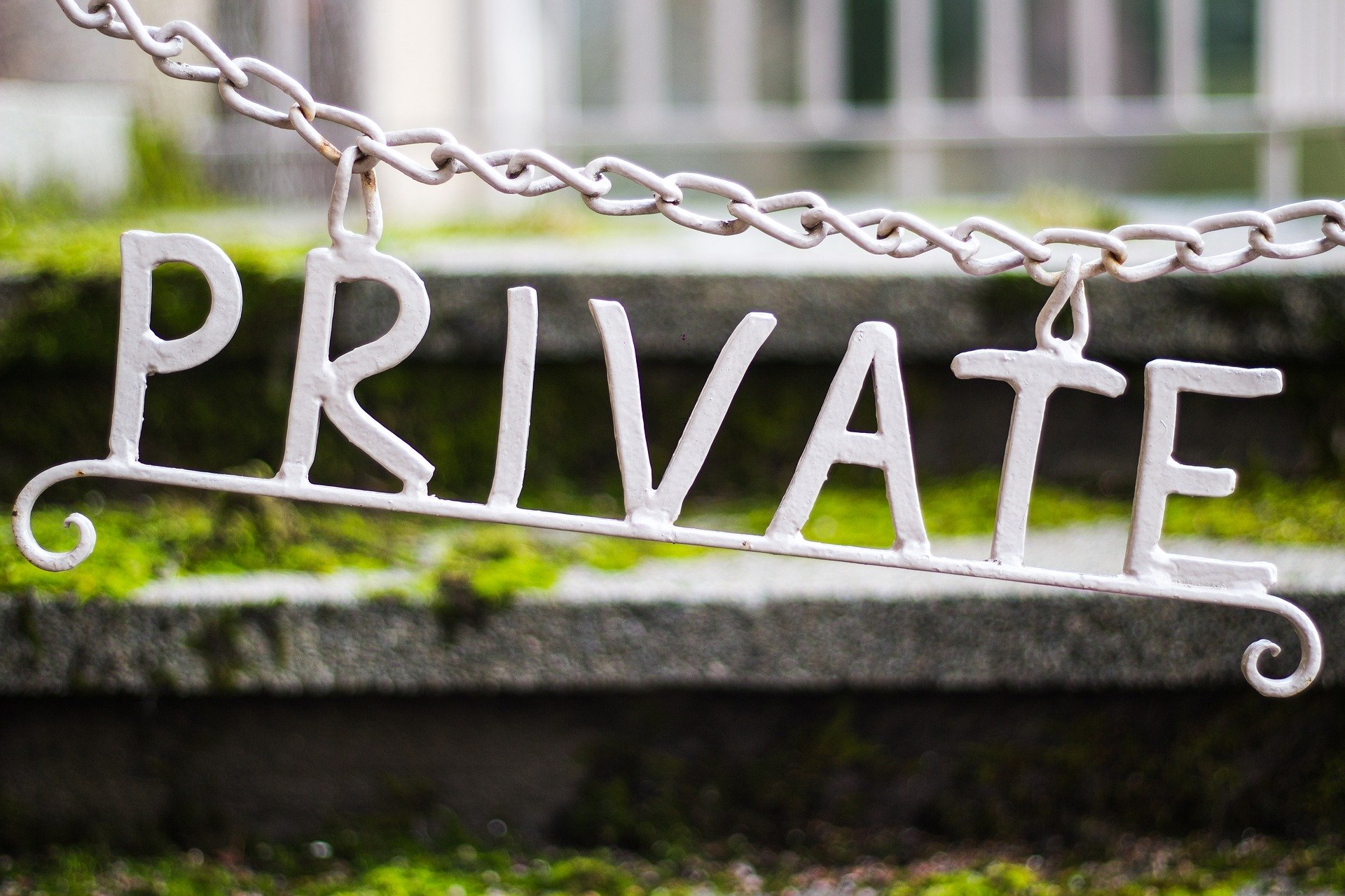A "private" sign hanging from chains. | Source: Pixabay.