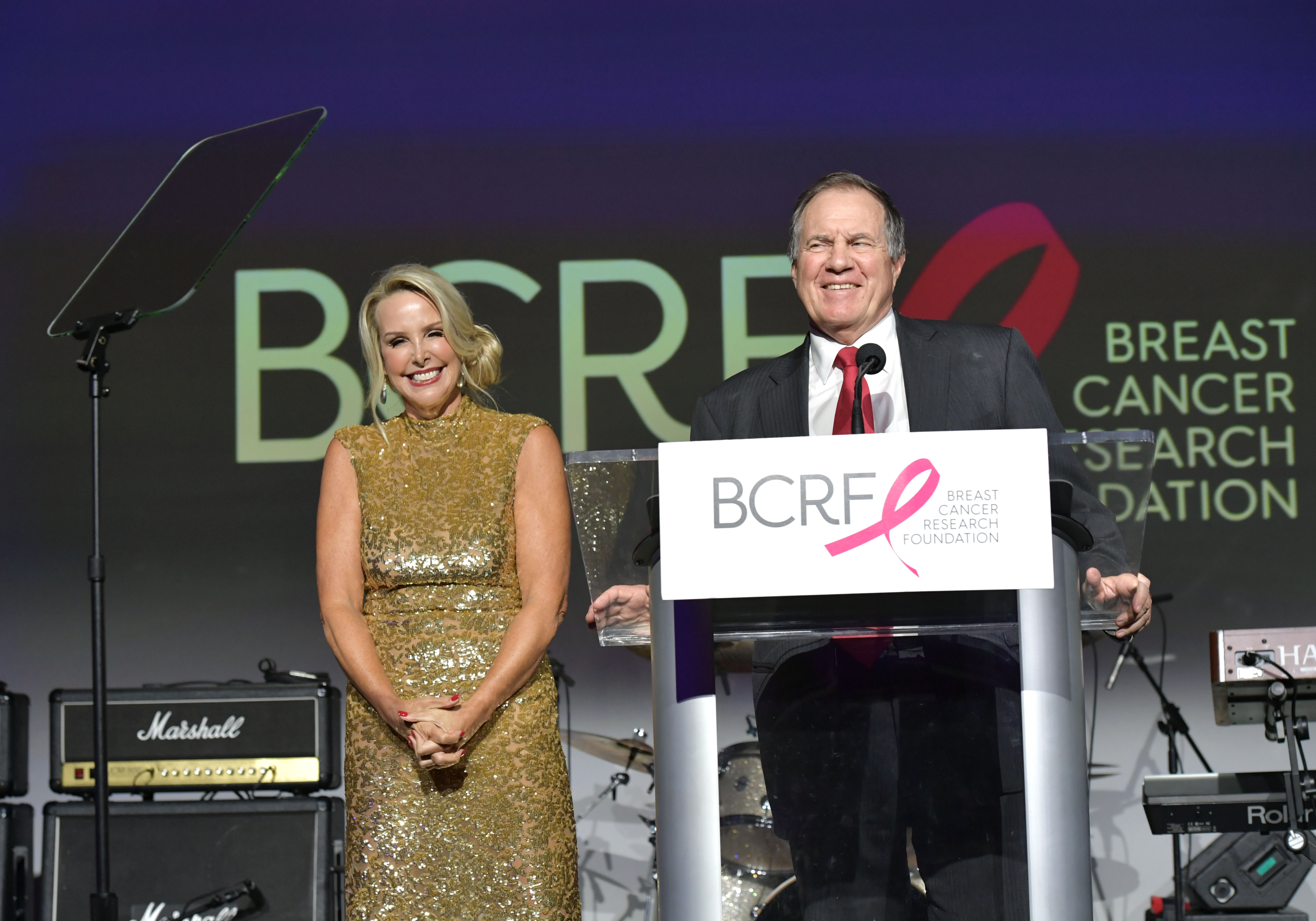 Linda Holliday and Bill Belichick on stage at the Breast Cancer Research Foundation's Boston Hot Pink Party in 2019, in Boston, Massachusetts. | Source: Getty Images