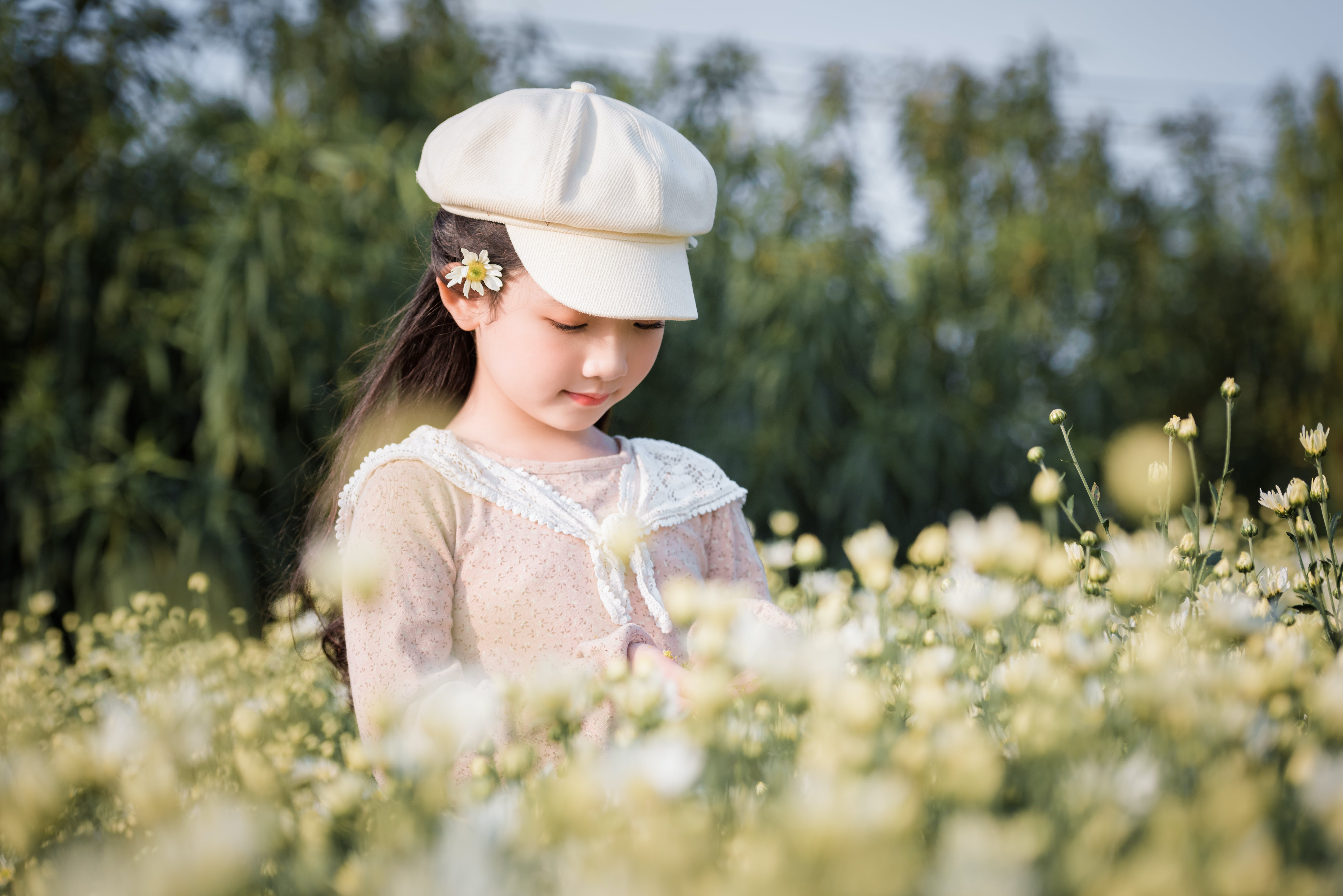 A young girl standing in a flower field. | Source: Pexels