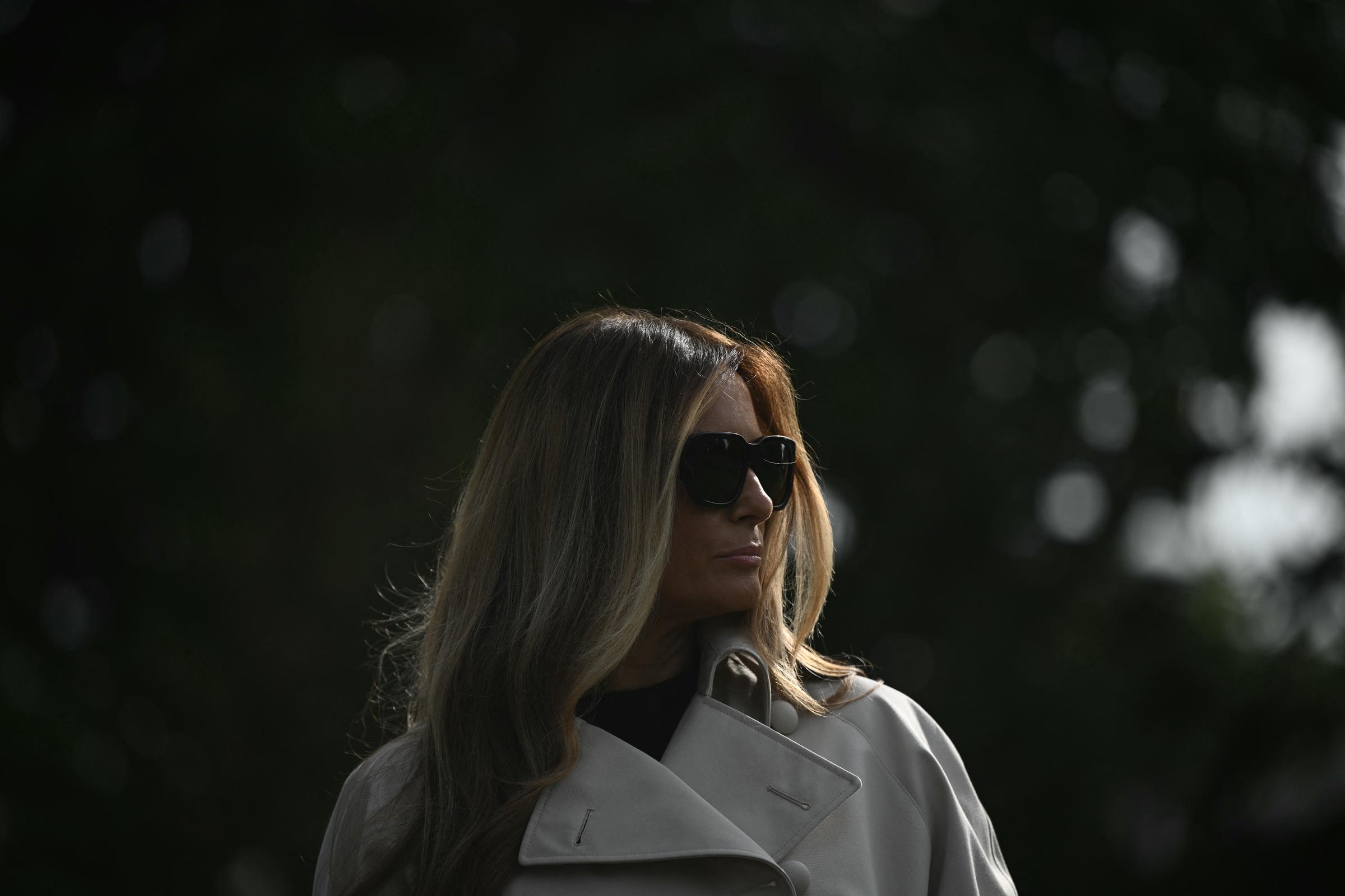 Melania Trump listens as Donald Trump speaks as they depart from the South Lawn of the White House in Washington, DC, on April 25, 2025 | Source: Getty Images