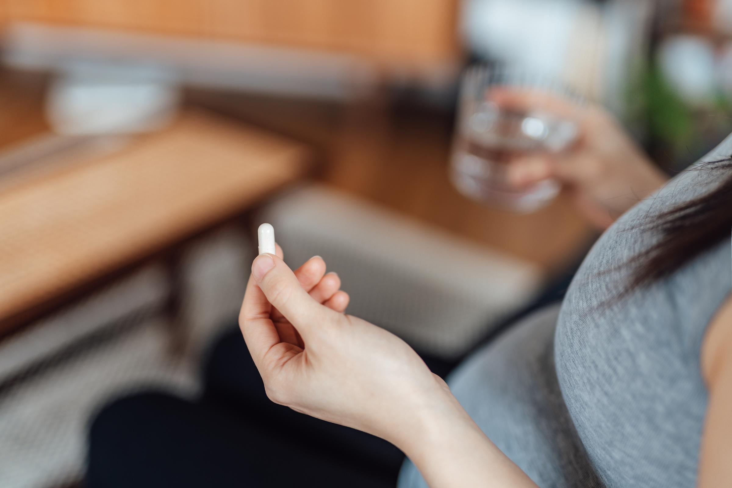 A pregnant woman taking medication | Source: Getty Images