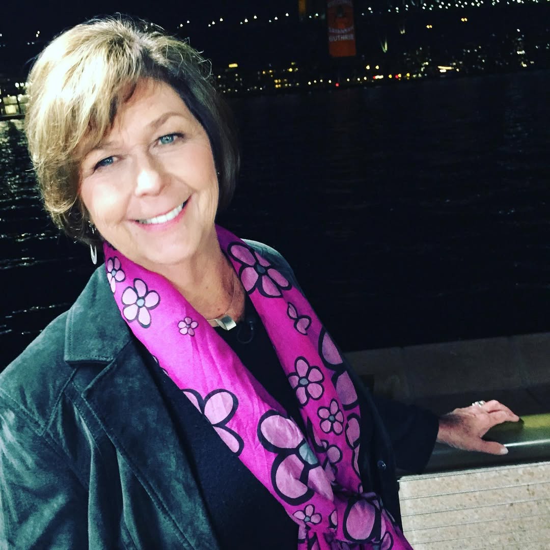 Nancy Guthrie smiles warmly at the camera and appears to be standing on a waterfront walkway or bridge, with her hand resting on a railing, from a post dated January 27, 2021. | Source: Instagram/savannahguthrie