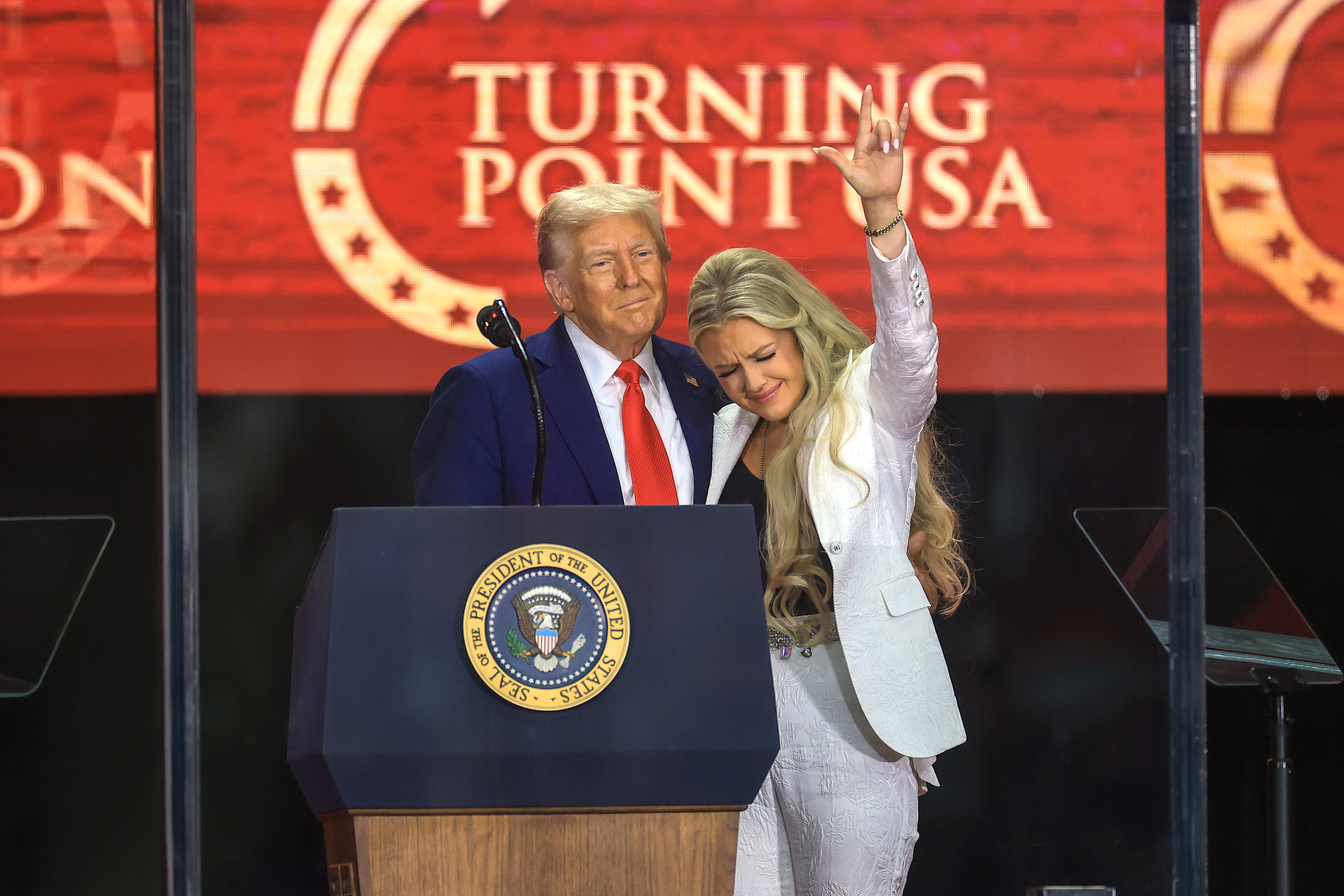 Donald Trump and Erika Kirk standing in front of a Turning Point USA backdrop. | Source: Getty Images