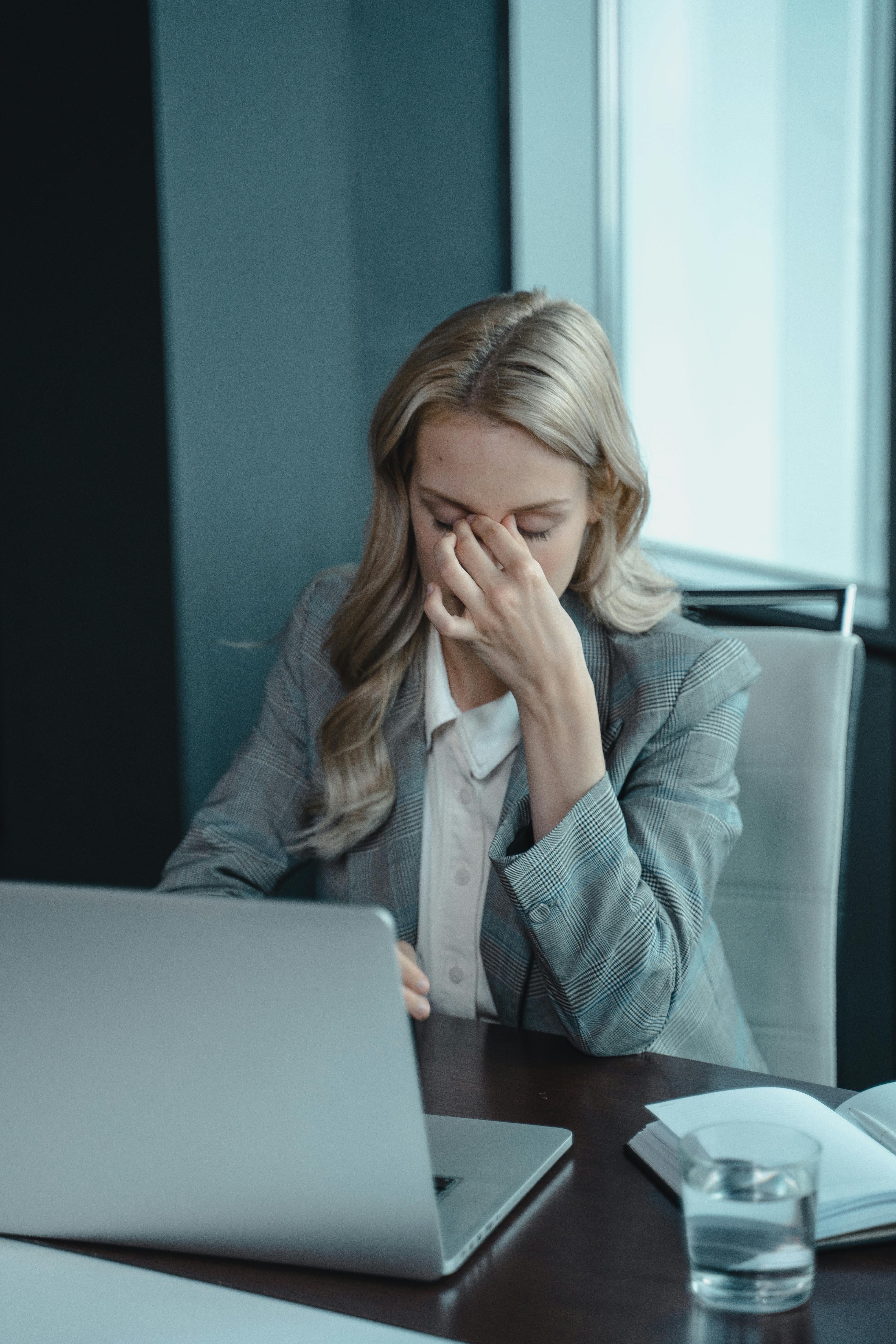A woman in deep stress at work | Source: Pexels