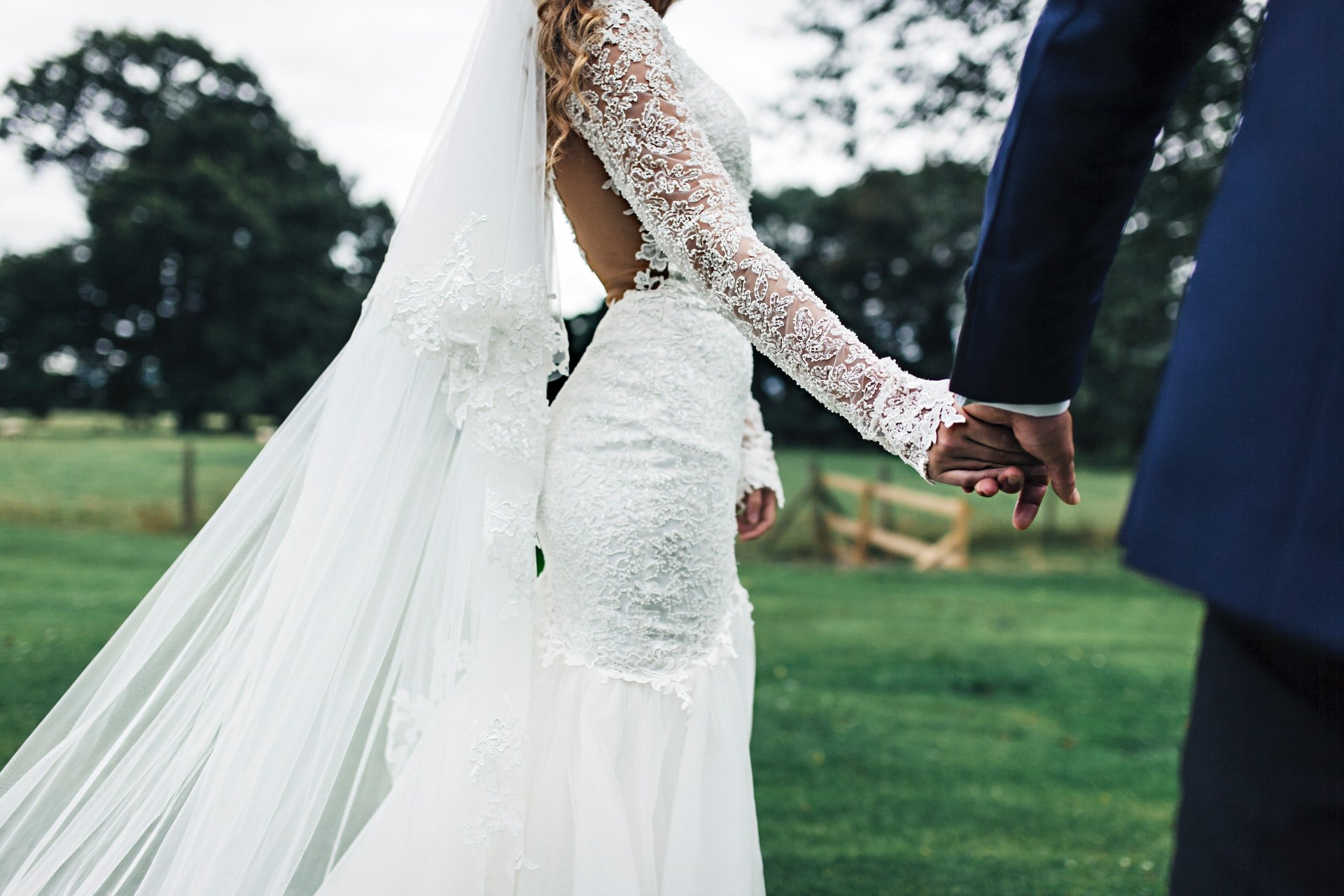 A newly-wed couple holding hands | Source: Unsplash