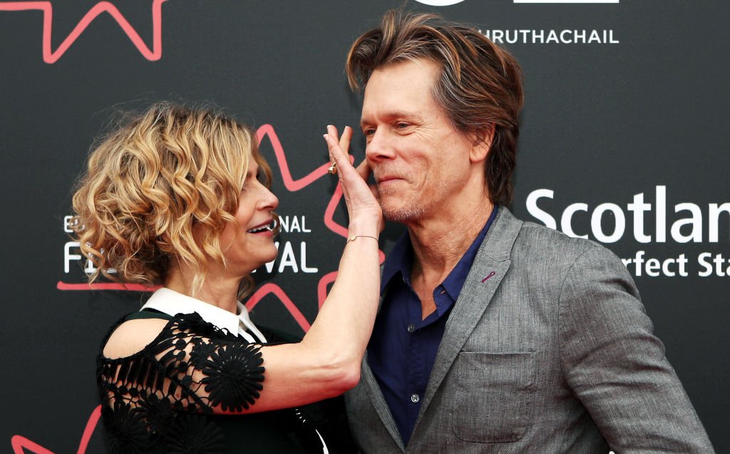 Kevin Bacon's wife and director Kyra Sedgwick wipes something off his face as they attend the Story of a Girl world premiere on June 22, 2017 | Photo: Getty Images