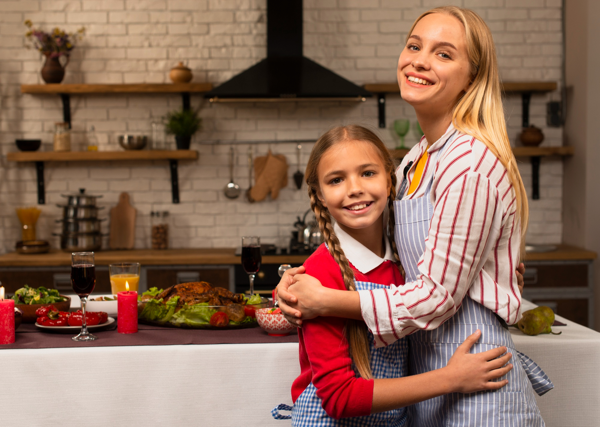 A mother-daughter duo hugging in the kitchen | Source: Freepik