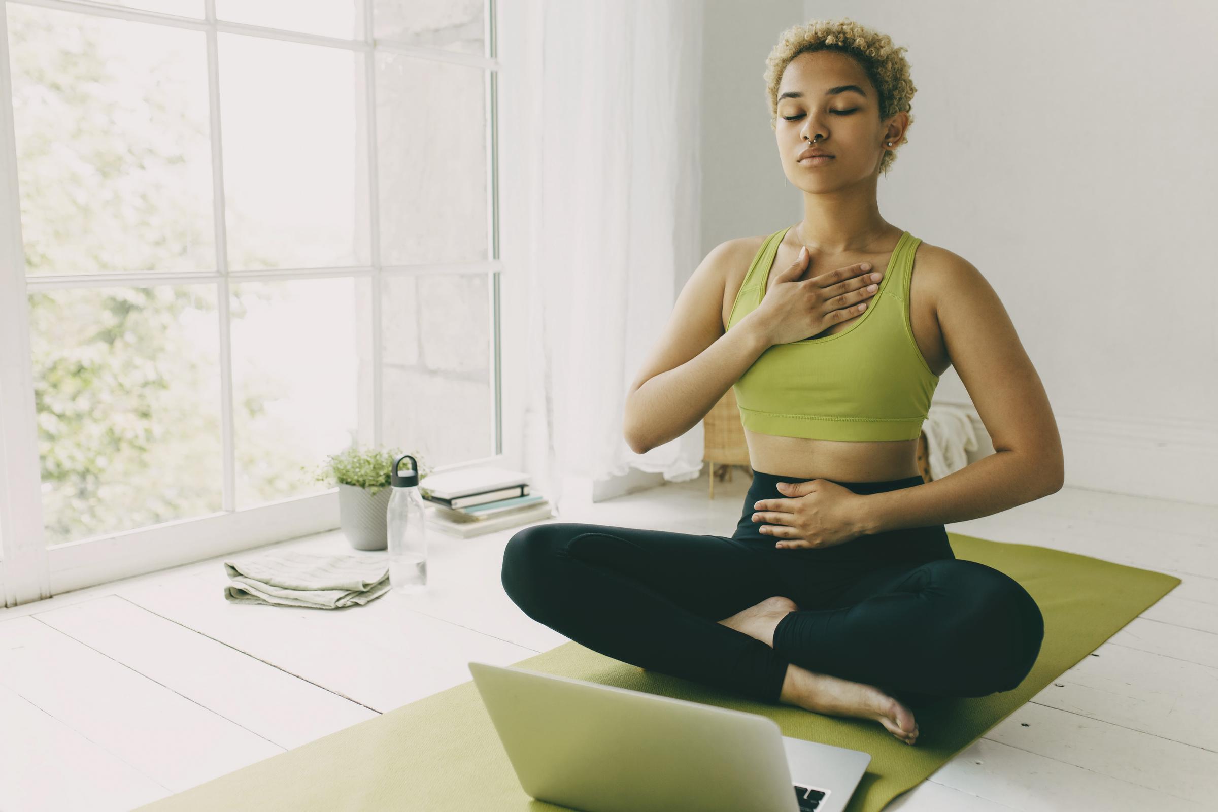 A woman practicing deep-belly breathing | Source: Shutterstock