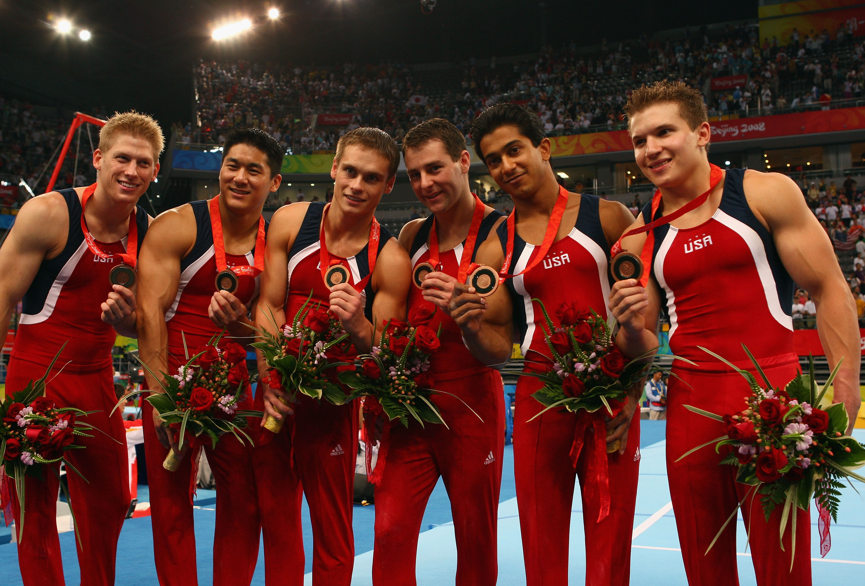 Alexander Artemev, Raj Bhavsar, Joey Hagerty, Jonathan Horton, Justin Spring, and Kevin Tan hold their bronze medals at the Beijing 2008 Olympics on August 12, 2008