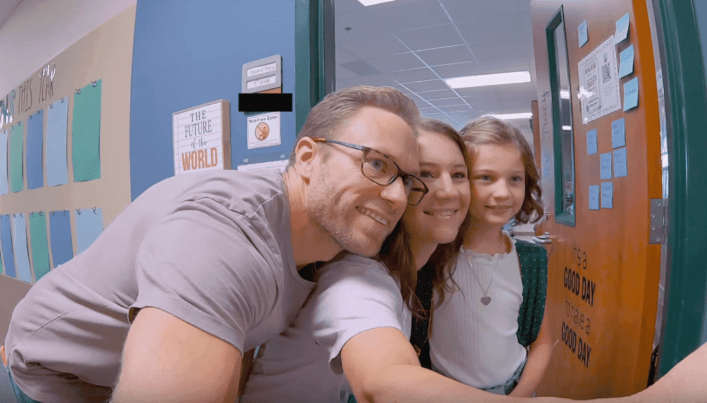 Adam, Danielle, and Blayke Busby taking a selfie at a school. | Photo: YouTube/It's a Buzz World