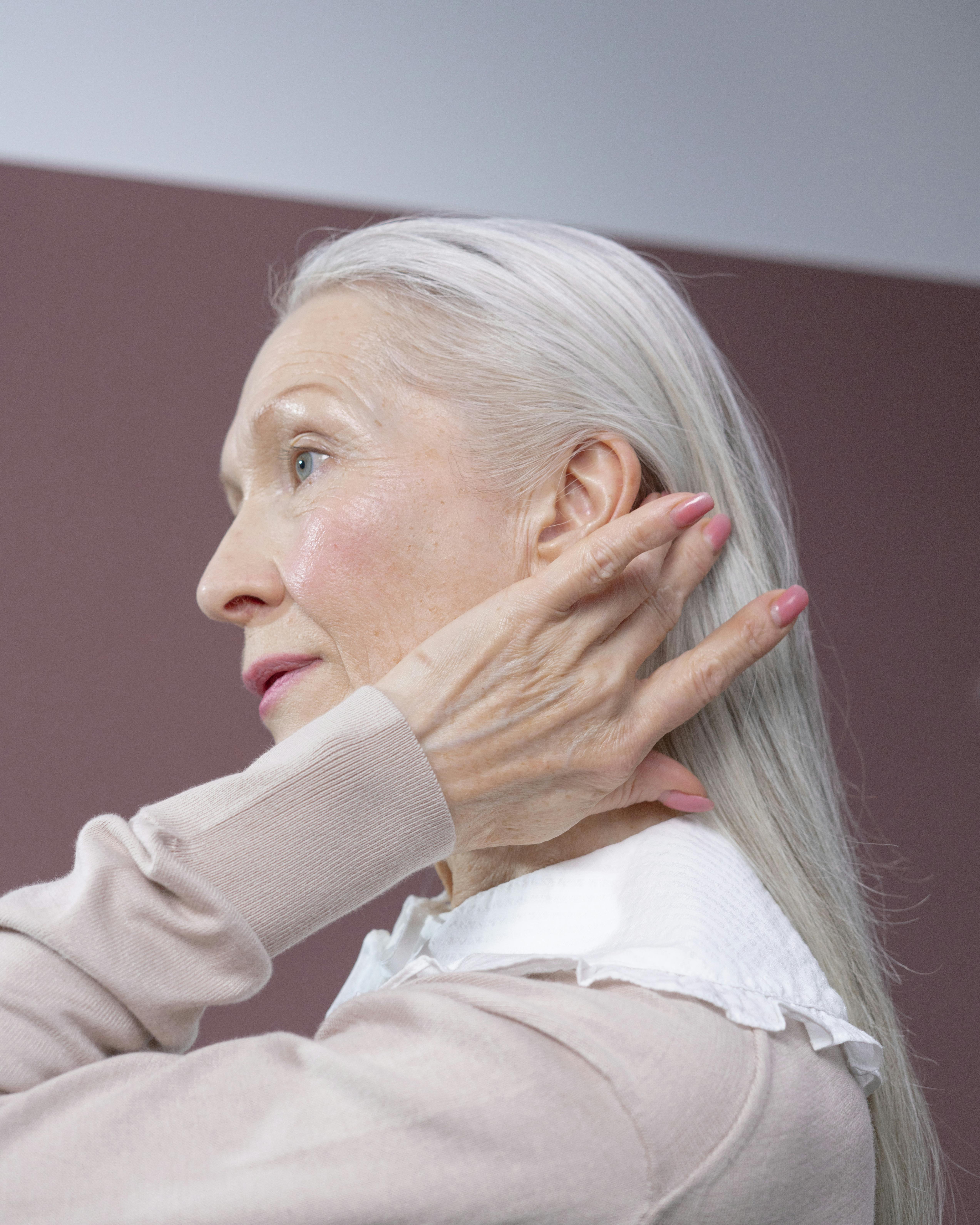 A woman fixing her hair | Source: Pexels