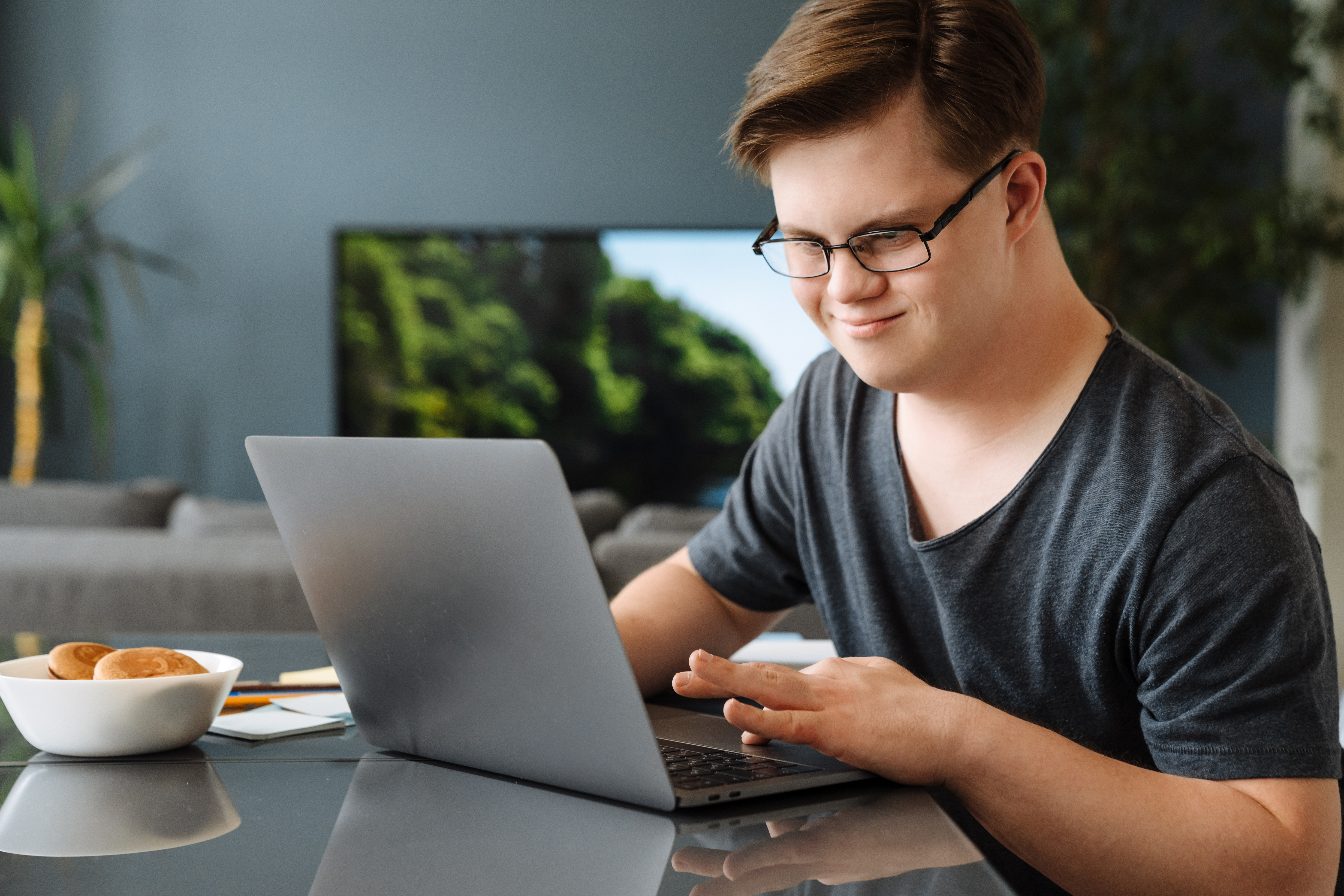 Man with Down syndrome working on his laptop. | Source: Shutterstock