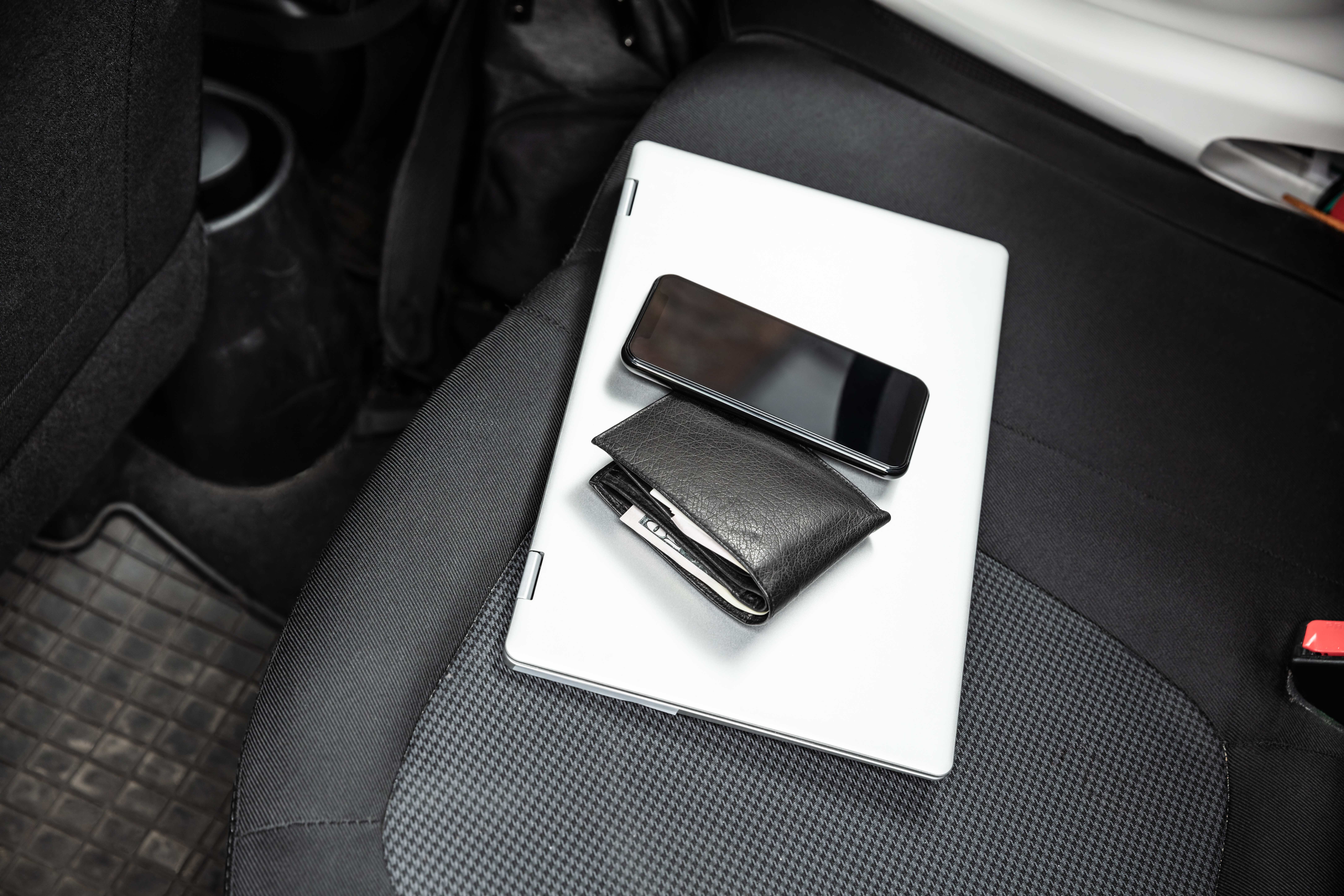 Personal belongings left on the back seat of a car | Source: Shutterstock