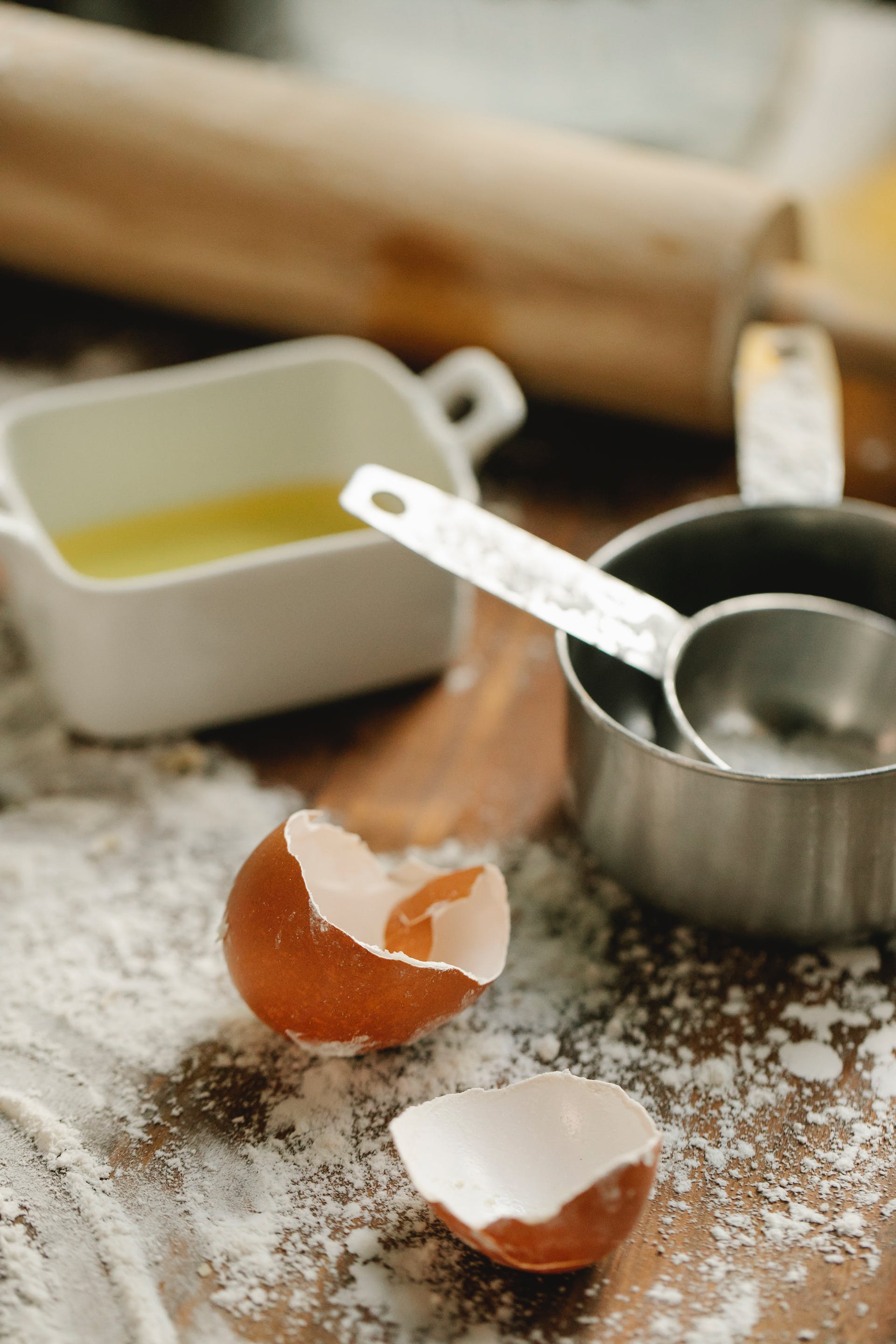 Eggshells and flour on a wooden surface | Source: Pexels