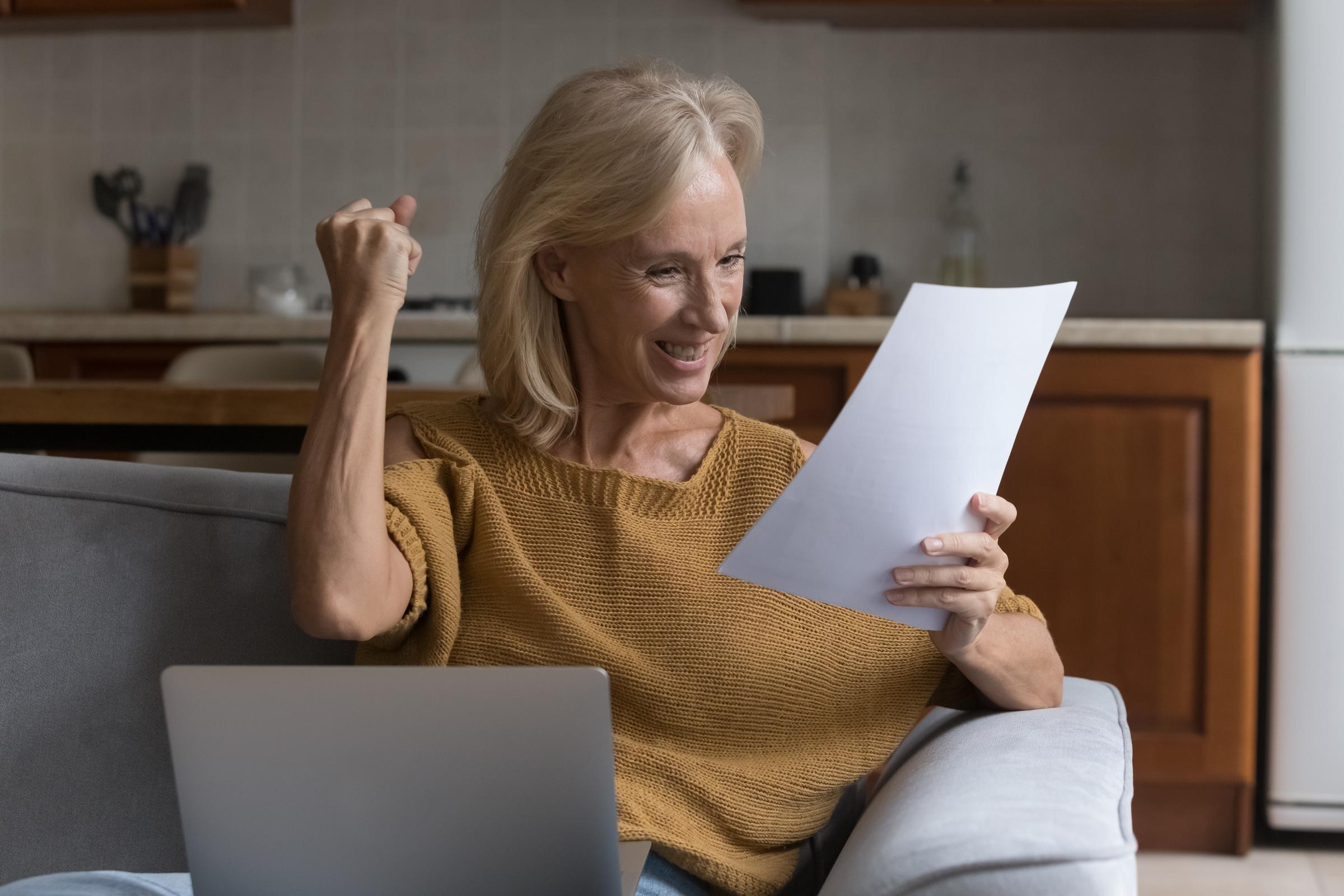 Woman looking victorious while looking at a document | Source: Shutterstock