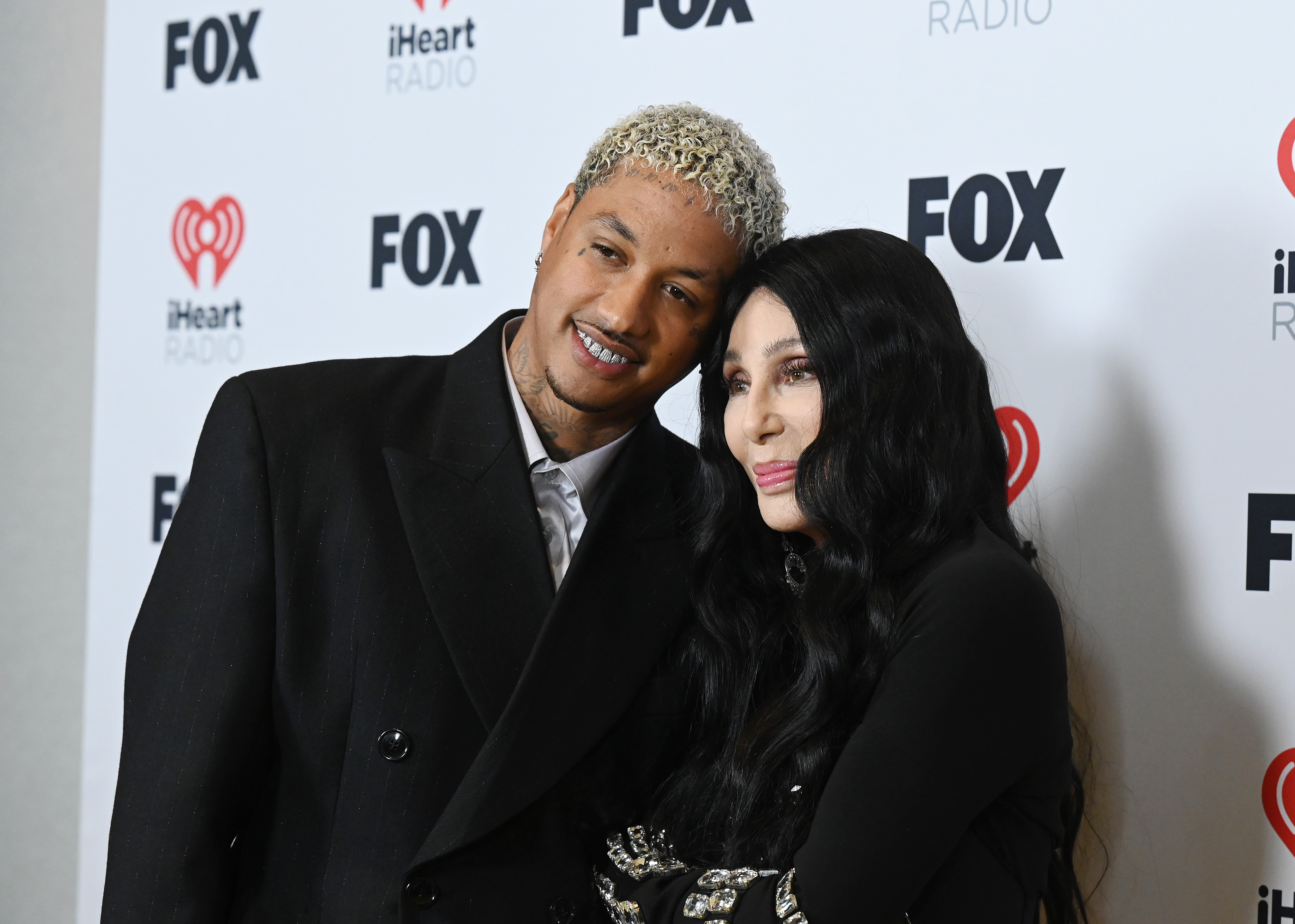 Alexander "AE" Edwards and Cher, winner of the Icon award, pose in the press room at the 2024 iHeartRadio Music Awards held at the Dolby Theatre on April 1, 2024, in Los Angeles, California | Source: Getty Images