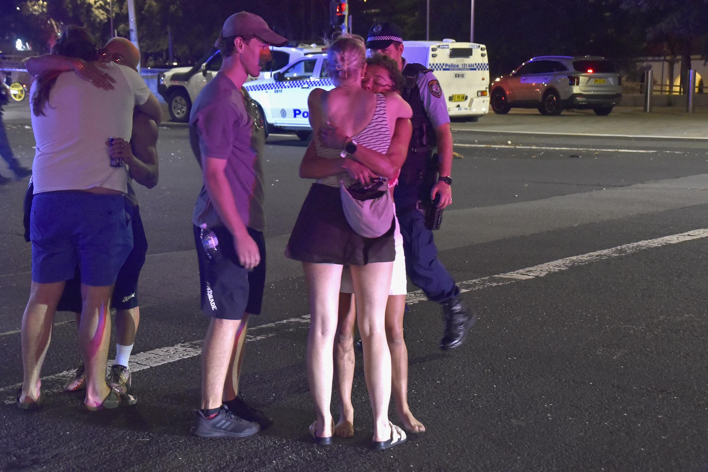 Shaken by the chaos, people embraced and consoled one another in the aftermath of the Bondi Beach shooting on December 14, 2025. The emotional toll of the attack — which struck during a family Hanukkah celebration — left bystanders traumatised as emergency services secured the area.