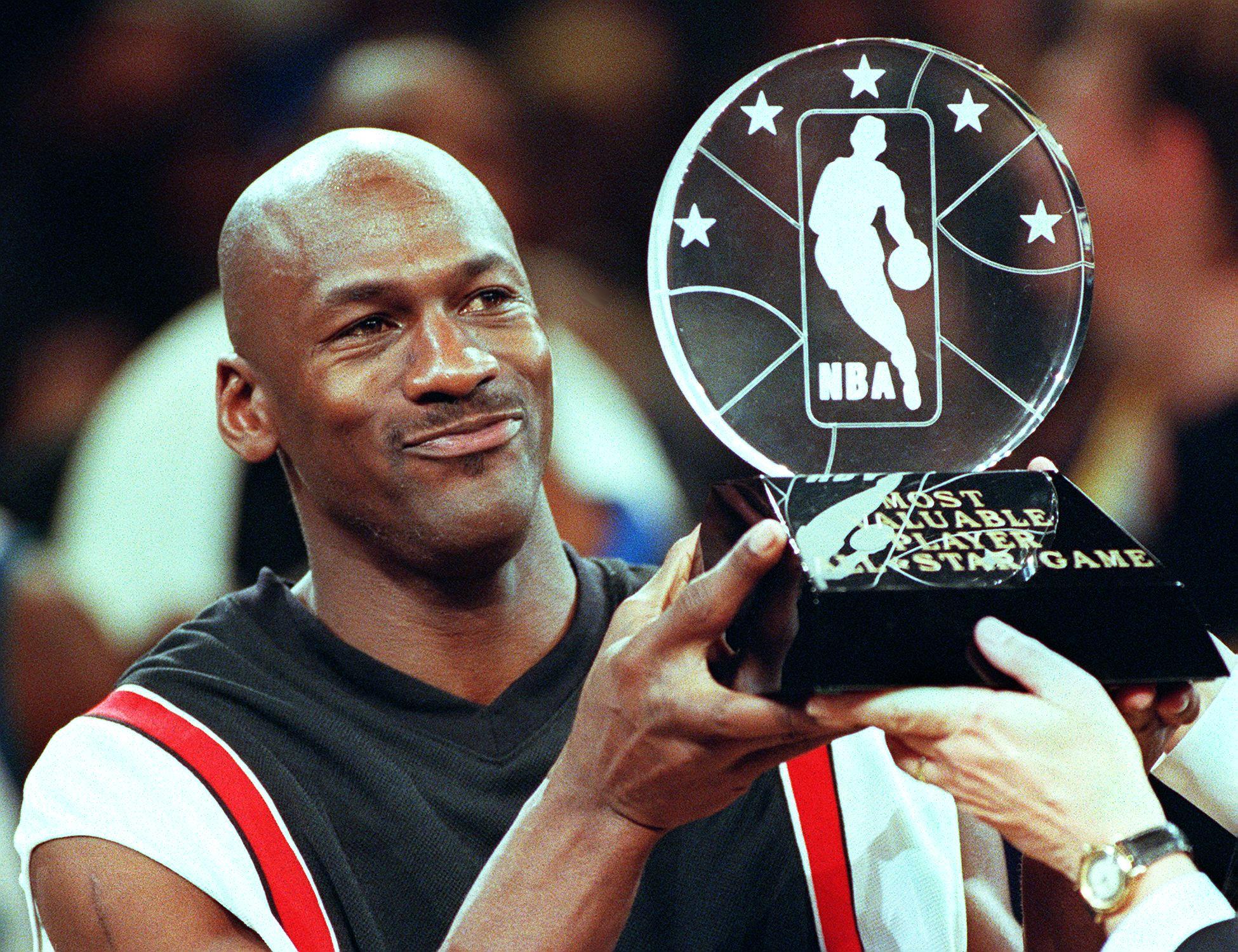 Michael Jordan holds up the Most Valuable Player trophy at Madison Square Garden | Source: Getty Images