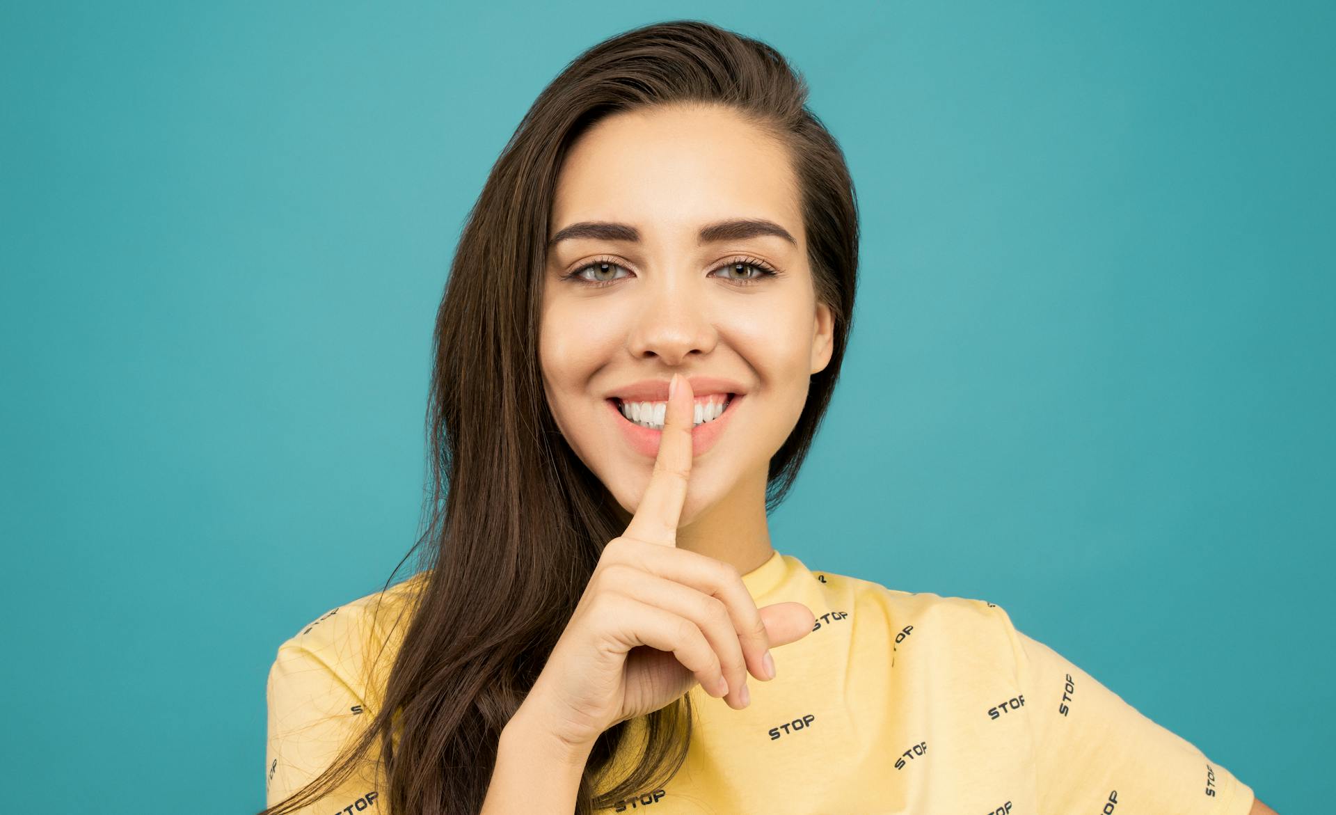 A woman pressing a finger to her lips | Source: Pexels