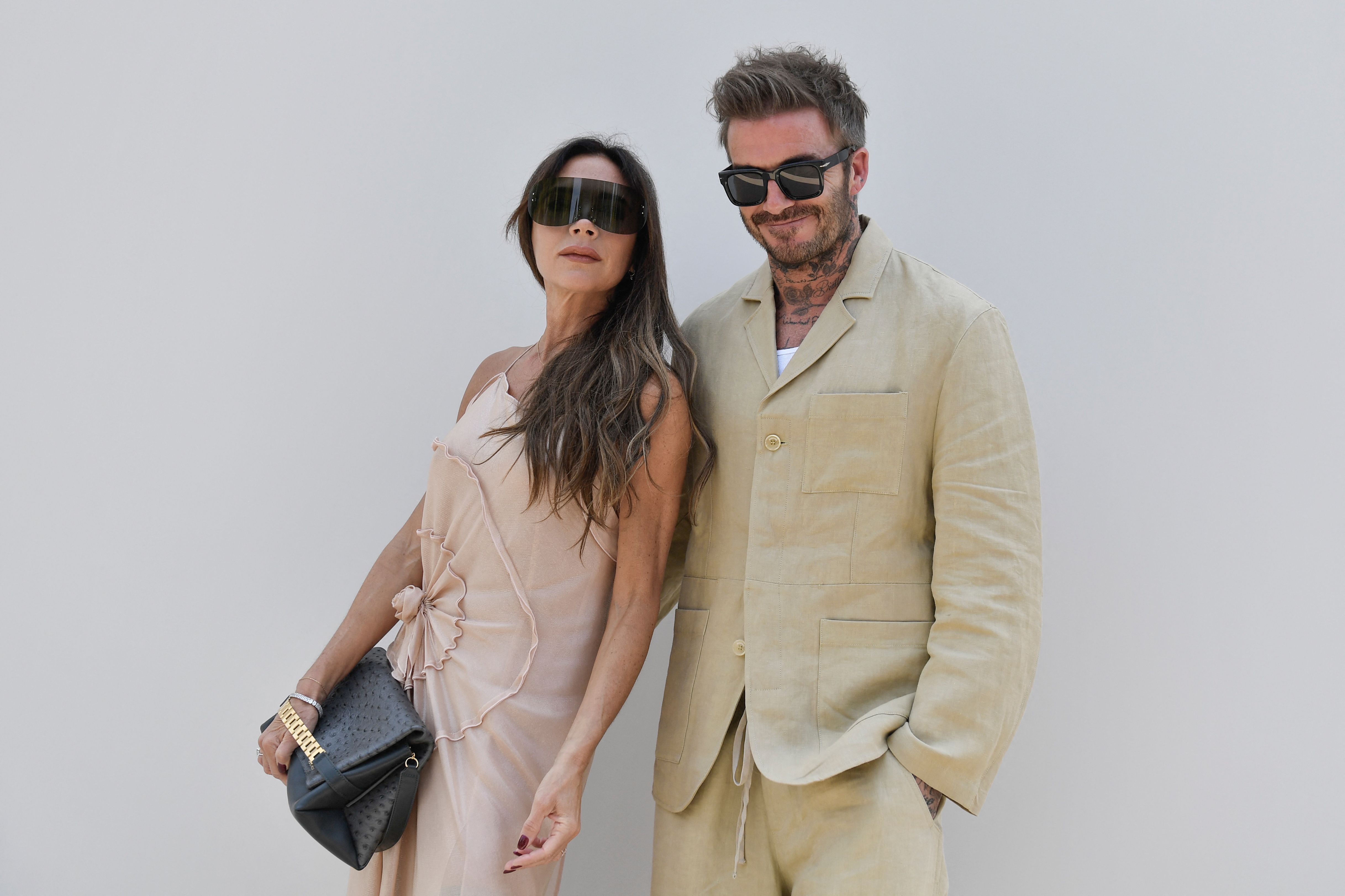 David Beckham and Victoria Beckham pose for photographs as they arrive at the Jacquemus Menswear Spring-Summer show as part of the Paris Fashion Week, at the Chateau de Versailles, in Versailles, southwest of Paris, on June 26, 2023 | Source: Getty Images