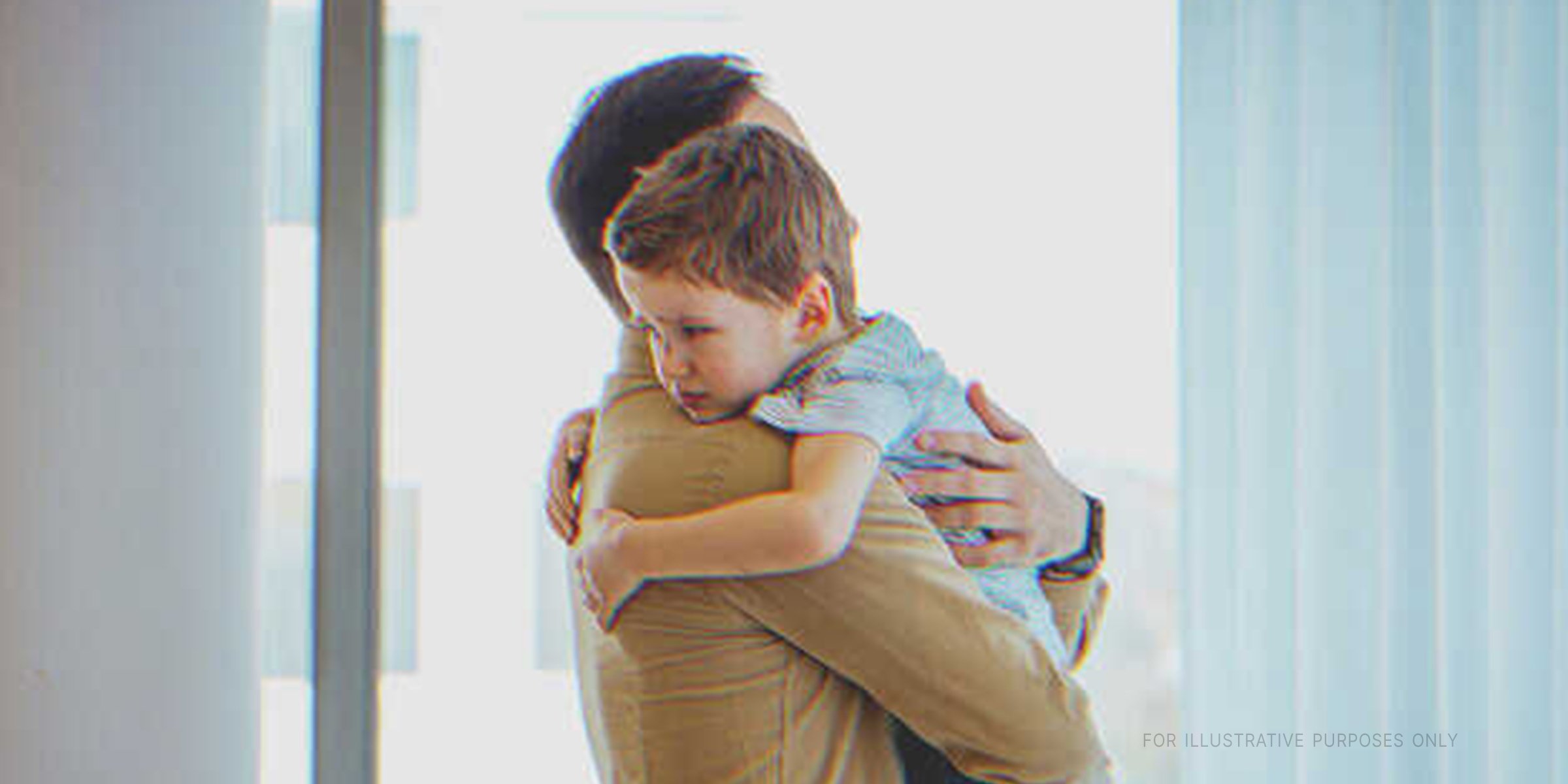 Father and young son hugging each other. | Source: Shutterstock