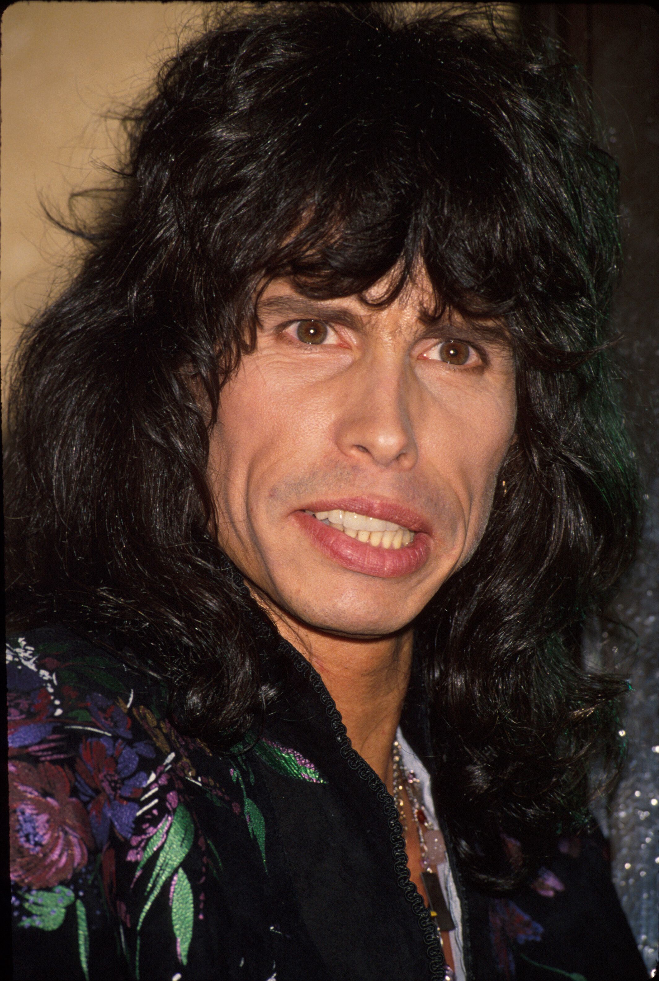 Steven Tyler smiles in a throwback photo from his youth. | Source: Getty Images