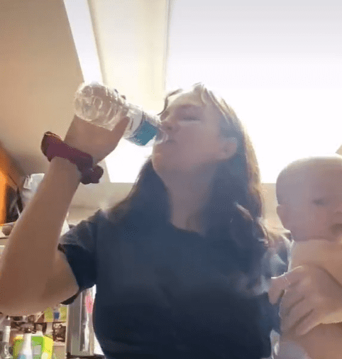 Stay-at-home mother Sierra Nicole holding her baby son while drinking water. | Source: tiktok.com/sierra_not_ciara