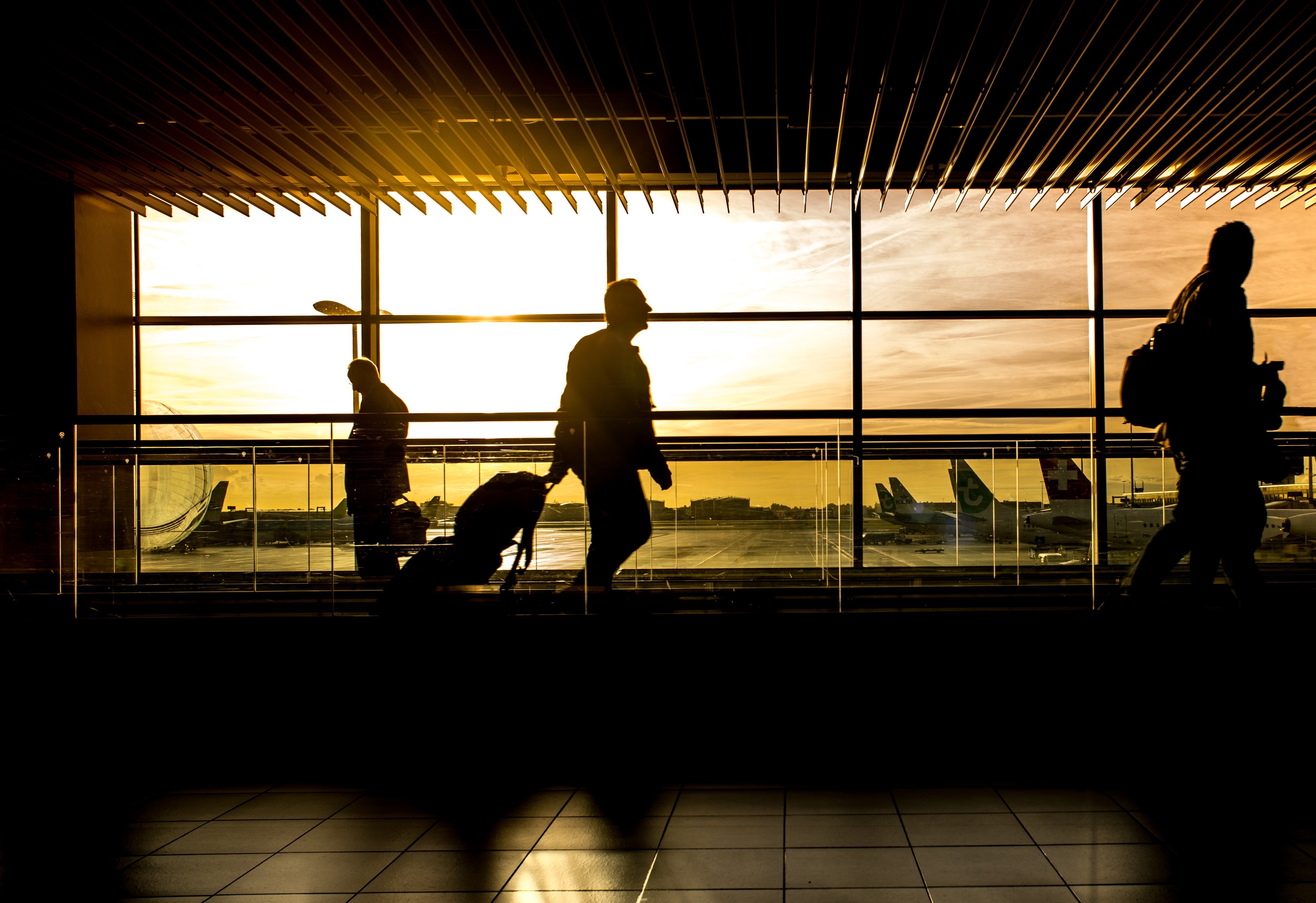 People moving around in an airport. | Source: Pexels