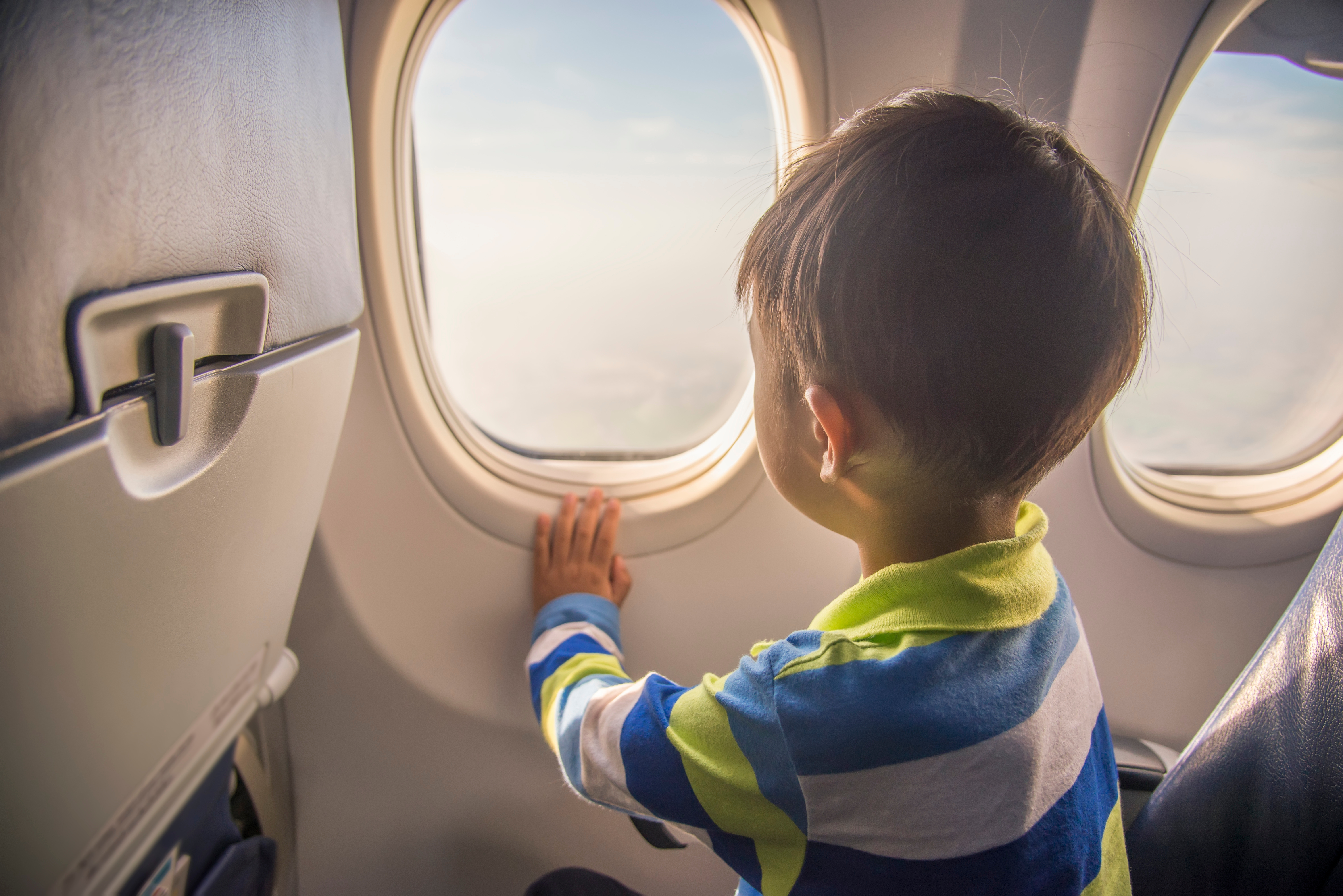 A child looking outside an airplane window | Source: Shutterstock