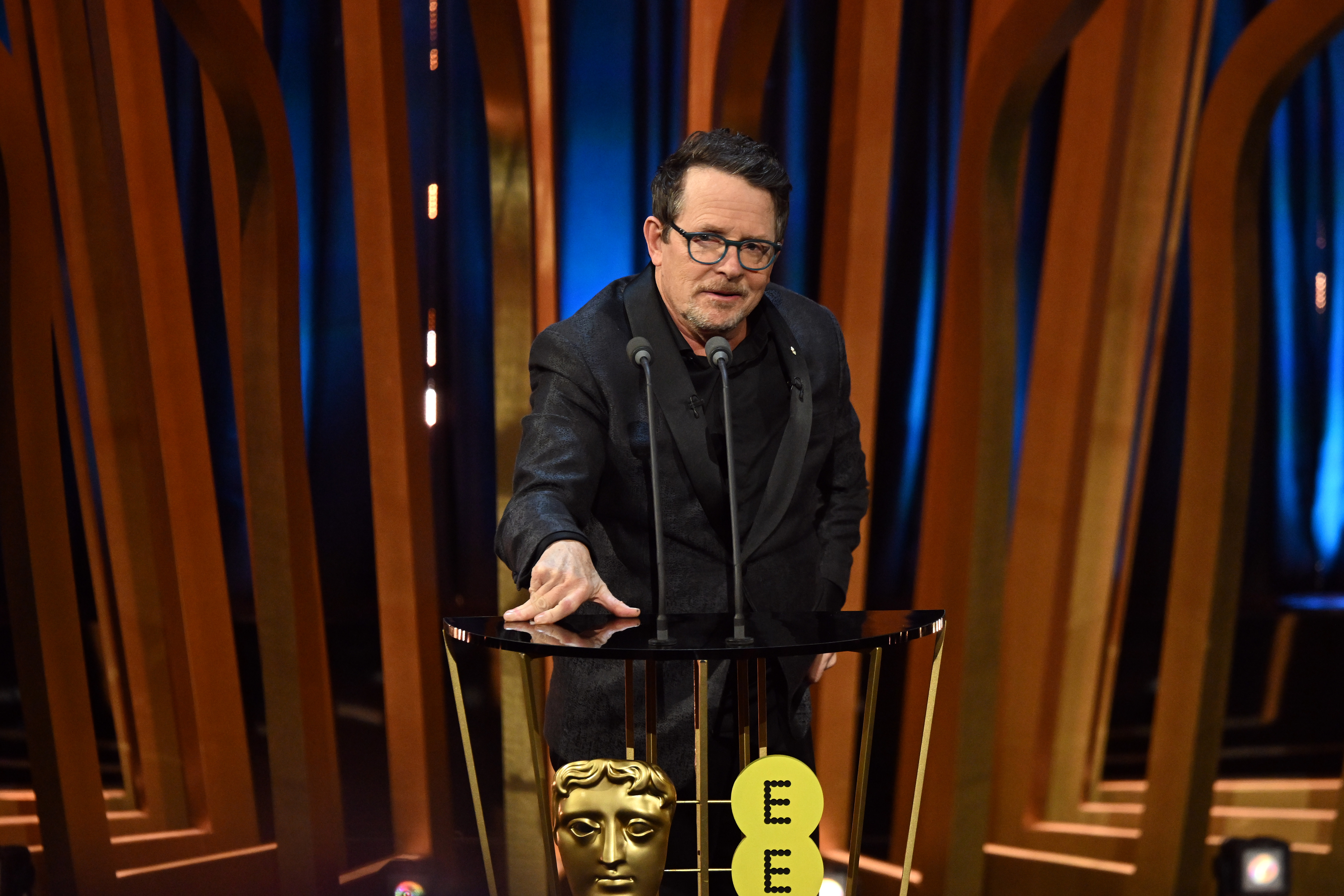 Michael J Fox presents the Best Film Award on stage during the EE BAFTA Film Awards at The Royal Festival Hall in London, England, on February 18, 2024. | Source: Getty Images