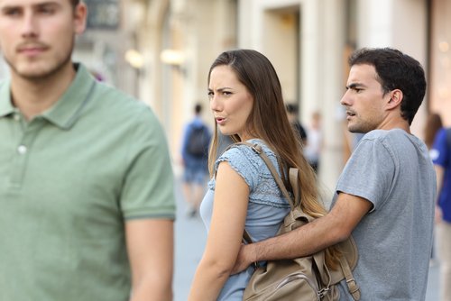 A woman in a relationship looking at another man. | Source: Shutterstock.