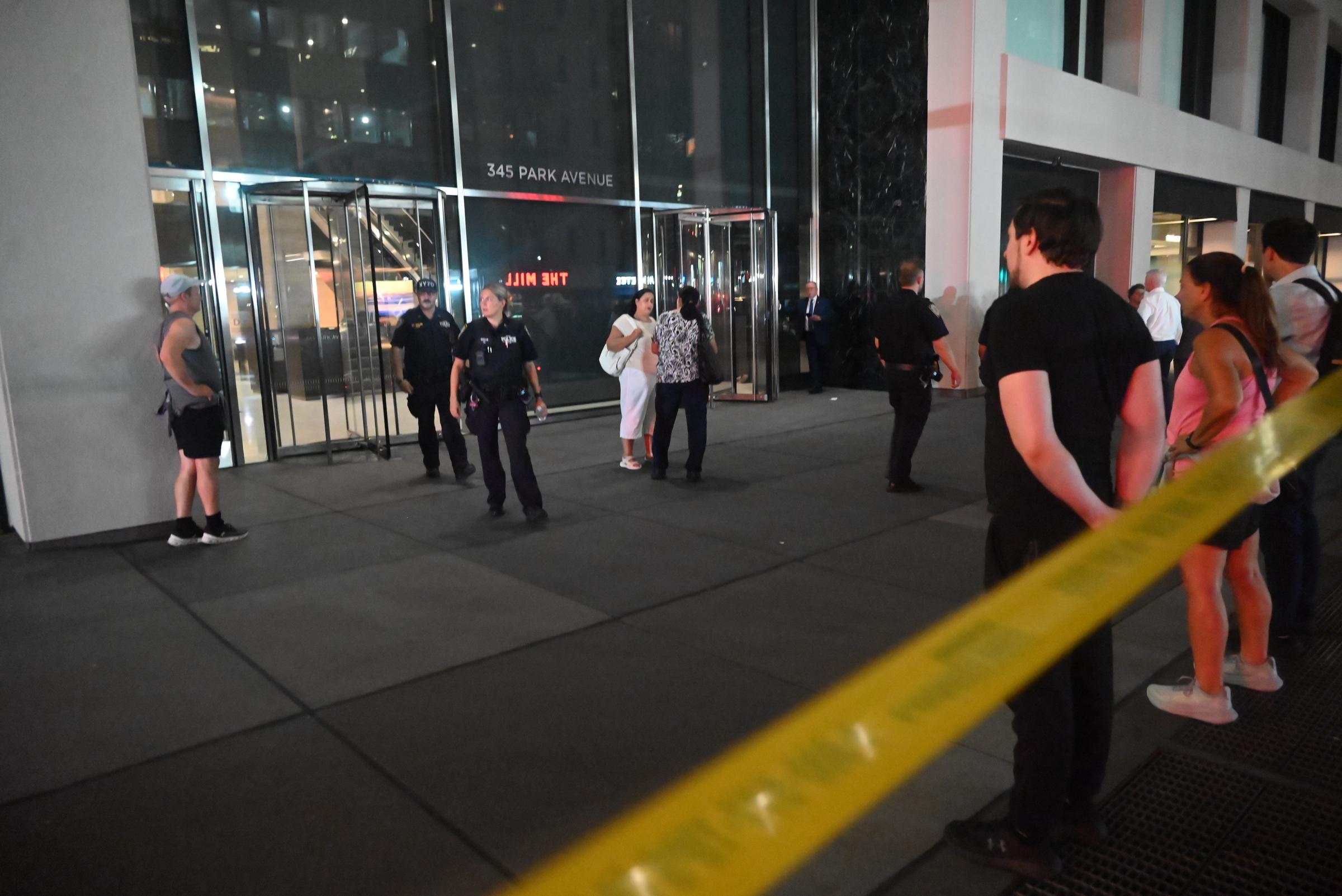 People who sheltered in place exit the building following an attack where NYPD police officer Didarul Islam was killed at 345 Park Avenue in New York City, on July 28, 2025 | Source: Getty Images