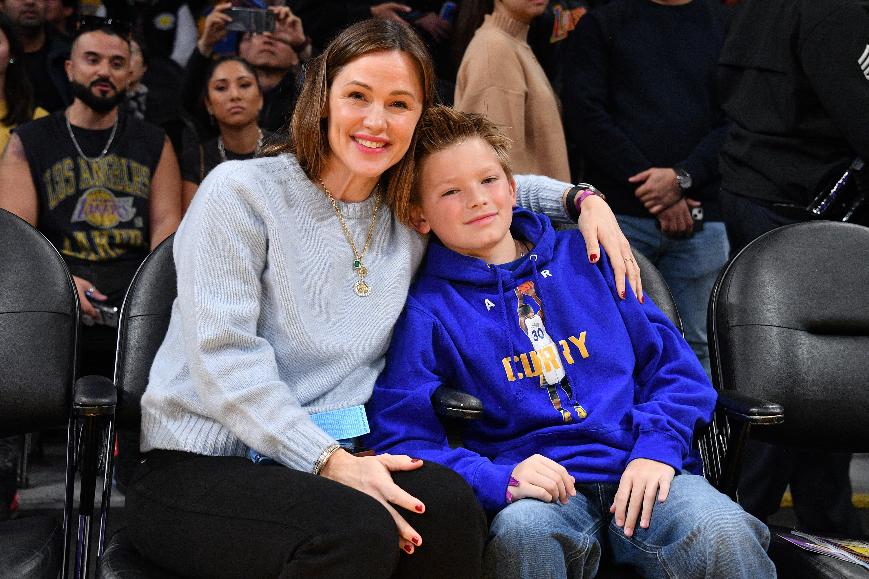 Jennifer Garner and Samuel Garner Affleck smile as they watch the basketball game between the Los Angeles Lakers and the Golden State Warriors at the Crypto.com Arena on March 5, 2023, in Los Angeles, California. | Source: Getty Images