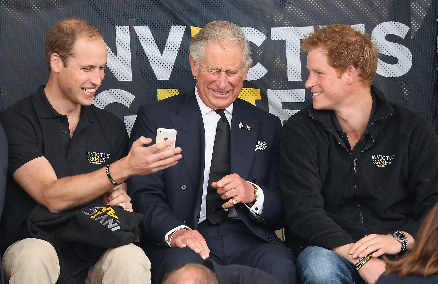 Prince William, Prince Harry and King Charles watch the athletics at Lee Valley Track during the Invictus Games on September 11, 2014 | Source: Getty Images