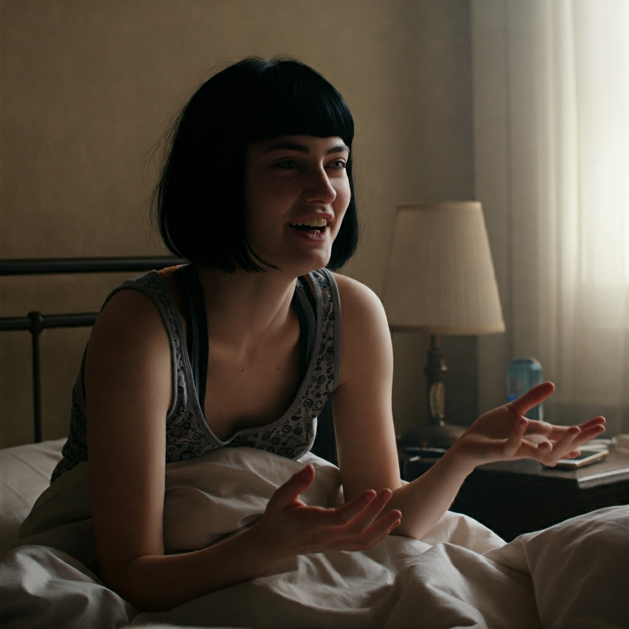 A woman talking happily while in bed | Source: Gemini