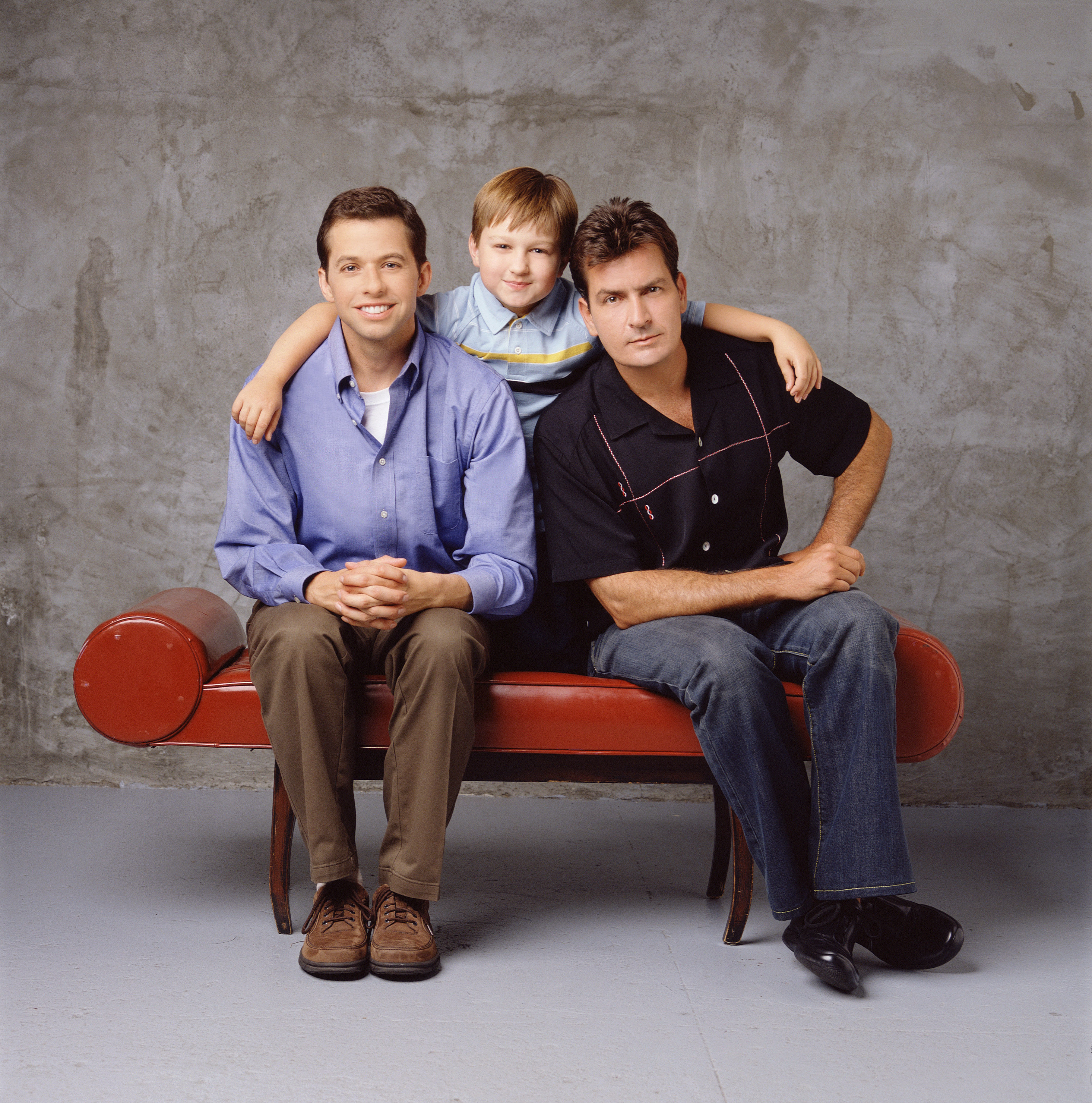 Promotional portrait of Jon Cryer, Angus T. Jones, and Charlie Sheen for 