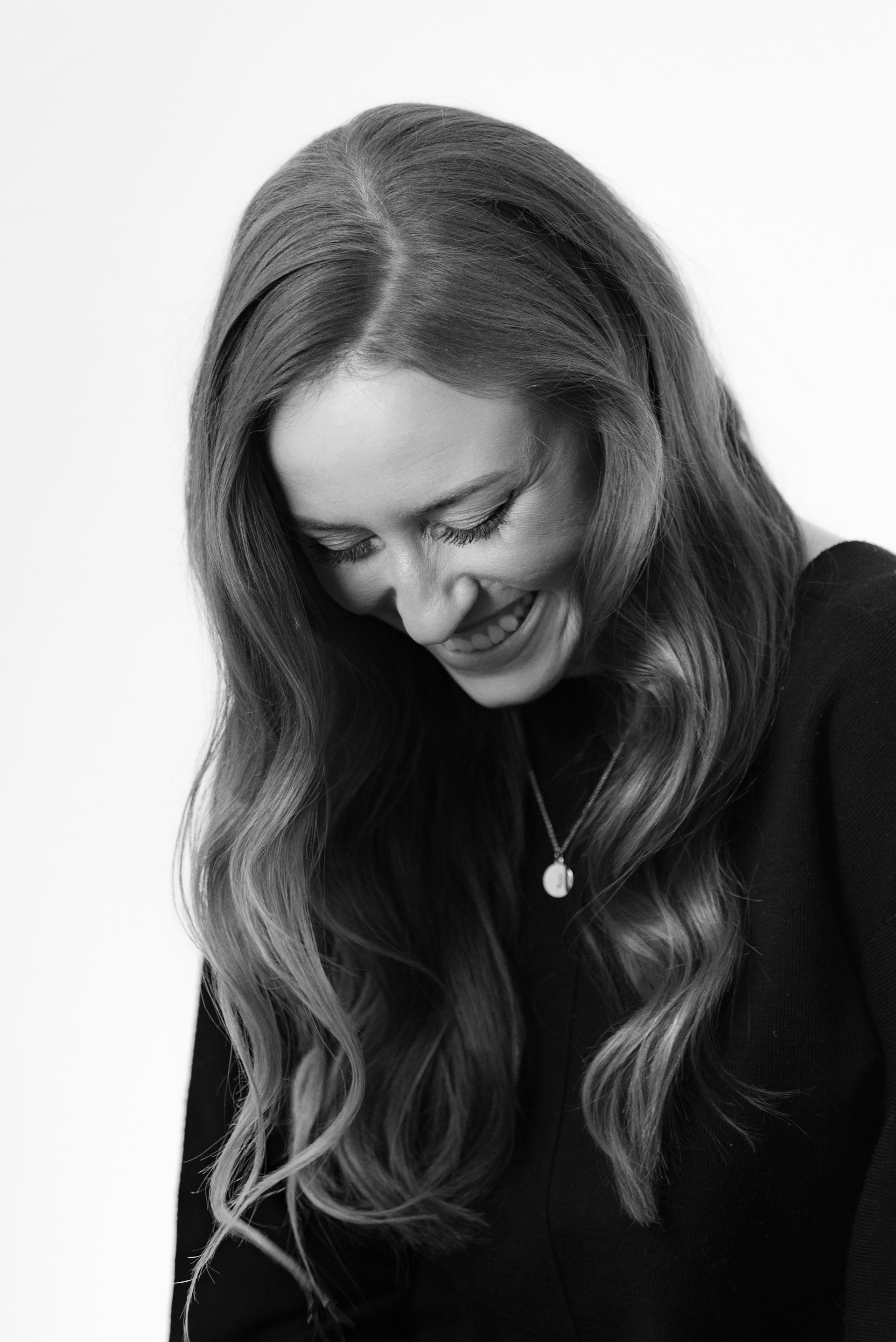 Grayscale shot of a woman laughing | Source: Unsplash