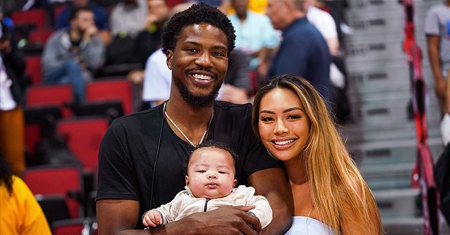 Malik Beasley and wife Montana Yao pose with their son Makai Beasley courtside at the NBA Summer League on July 07, 2019 | Photo: Getty Images