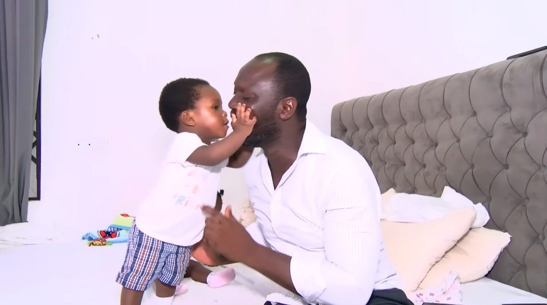Edmund Akrofi with one of his twins | Source: Youtube/Joy Learning Tv