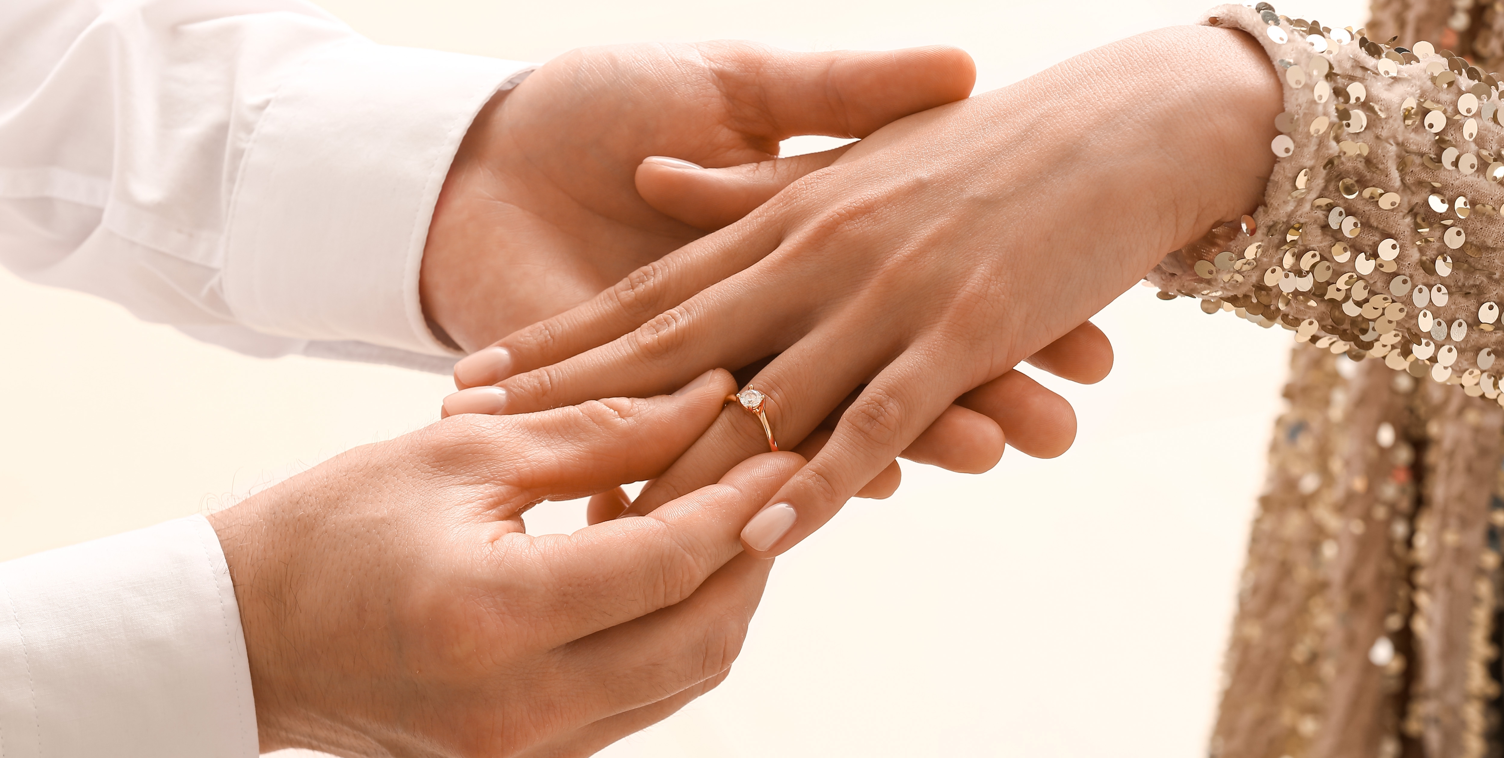 A man placing an engagement ring on a woman's hand | Source: Shutterstock