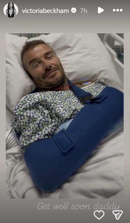 David Beckham in a hospital gown and blue arm sling, in a hospital bed, dated June 27, 2025, on Instagram Stories | Source: Instagram/victoriabeckham