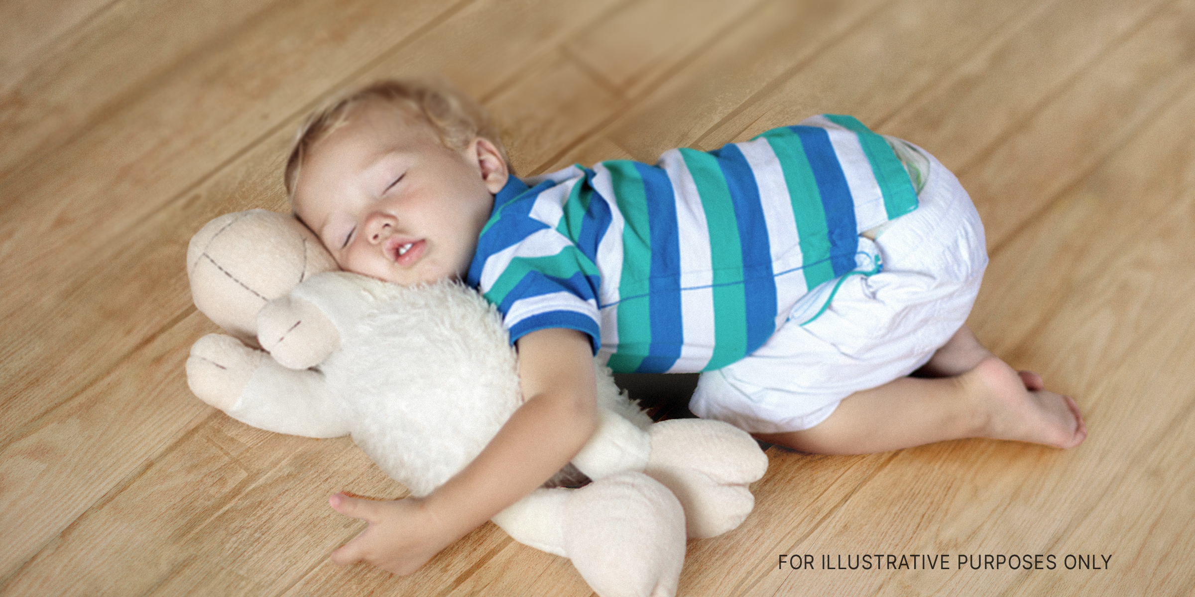 Toddler on the floor with teddy bear | Source: Shutterstock