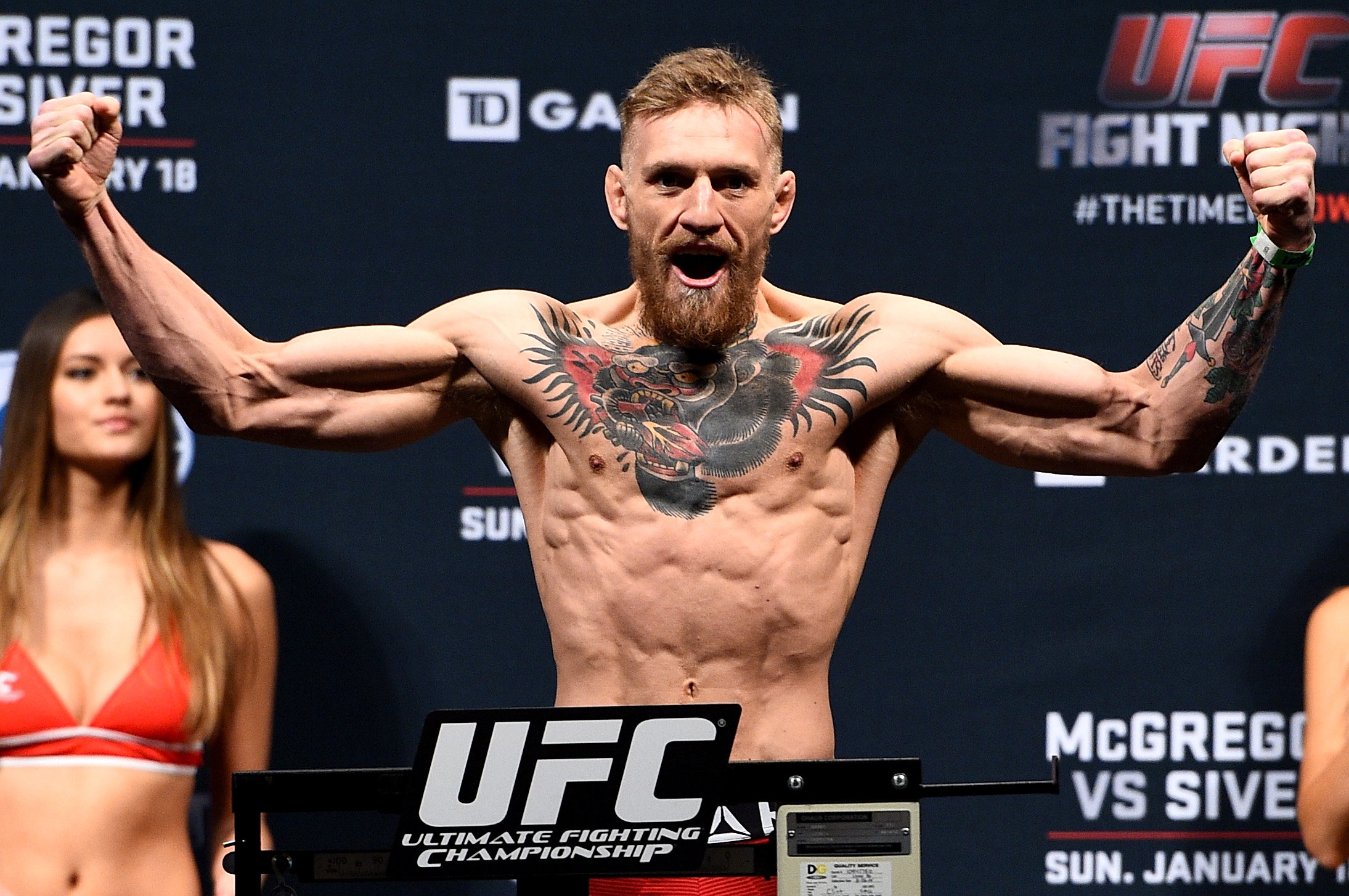 Conor McGregor poses on the scales during the UFC Fight Night Boston weigh-ins at the Orpheum Theatre on January 17, 2015. Still competing as a featherweight, the Irish star displayed the lean, shredded physique that helped define his early UFC success, with every muscle standing out after another demanding weight cut.