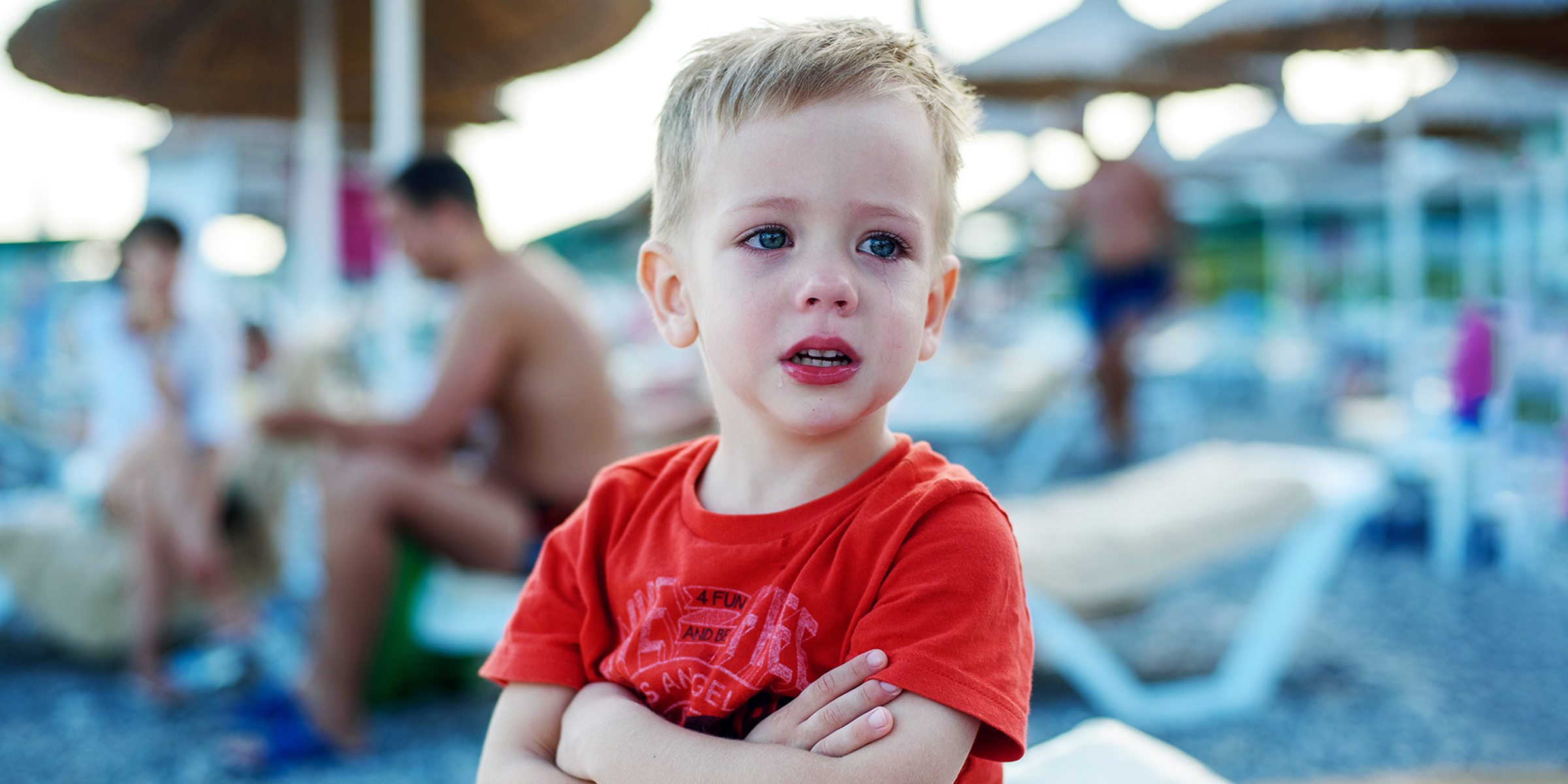 A boy crying on a beach | Source: Shutterstock