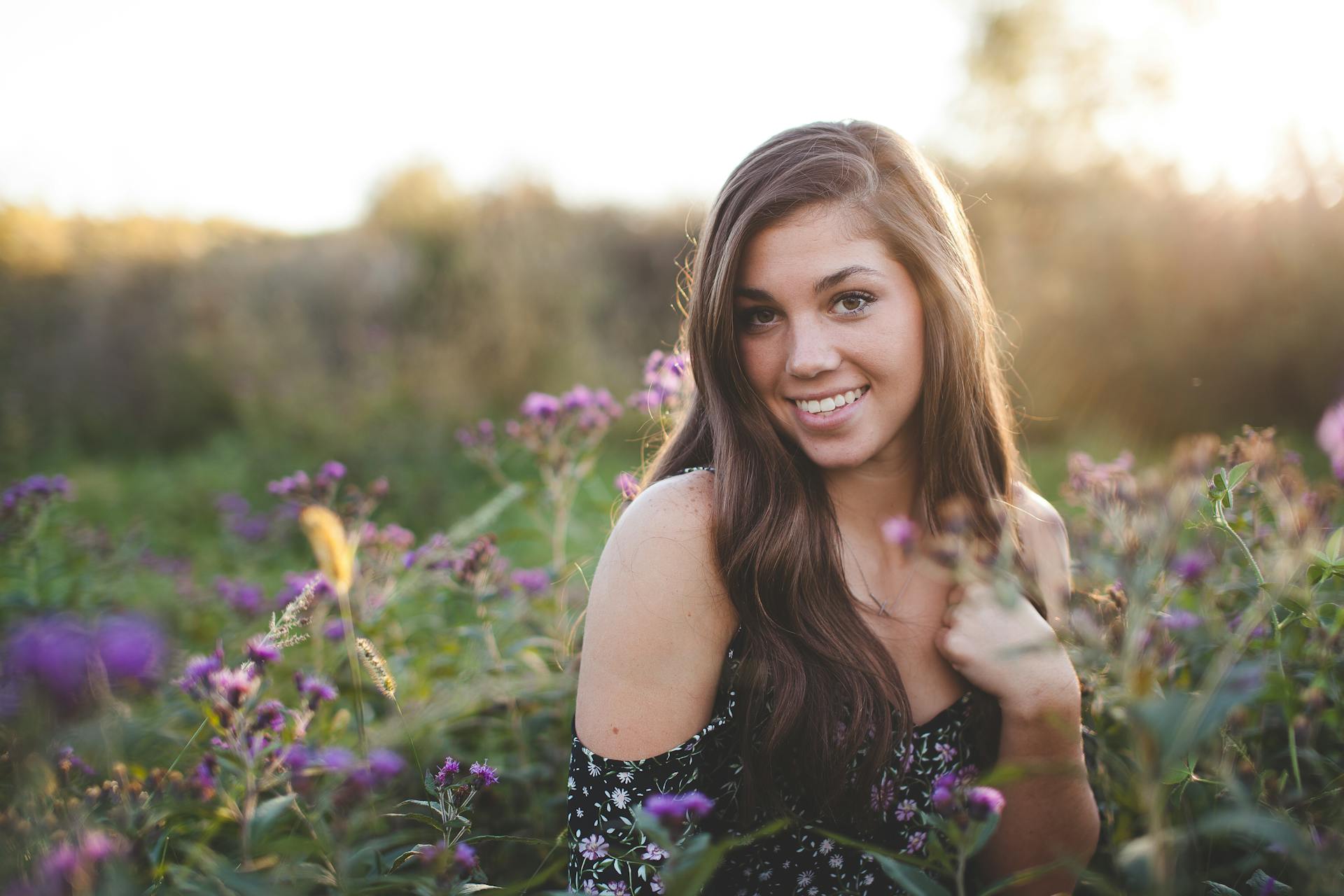 A woman standing among wildflowers | Source: Pexels