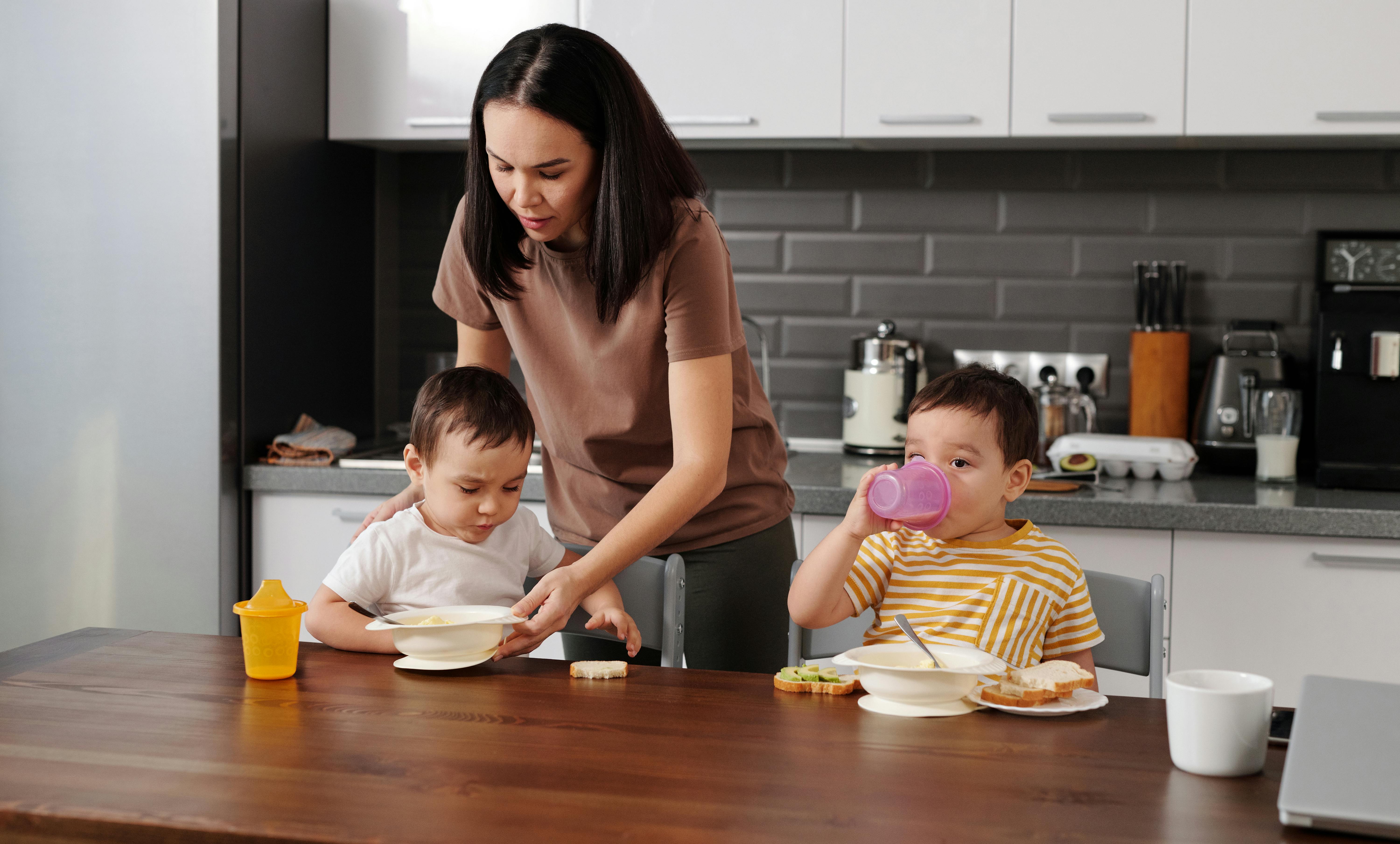 A woman taking care of the kids in the kitchen | Source: Pexels