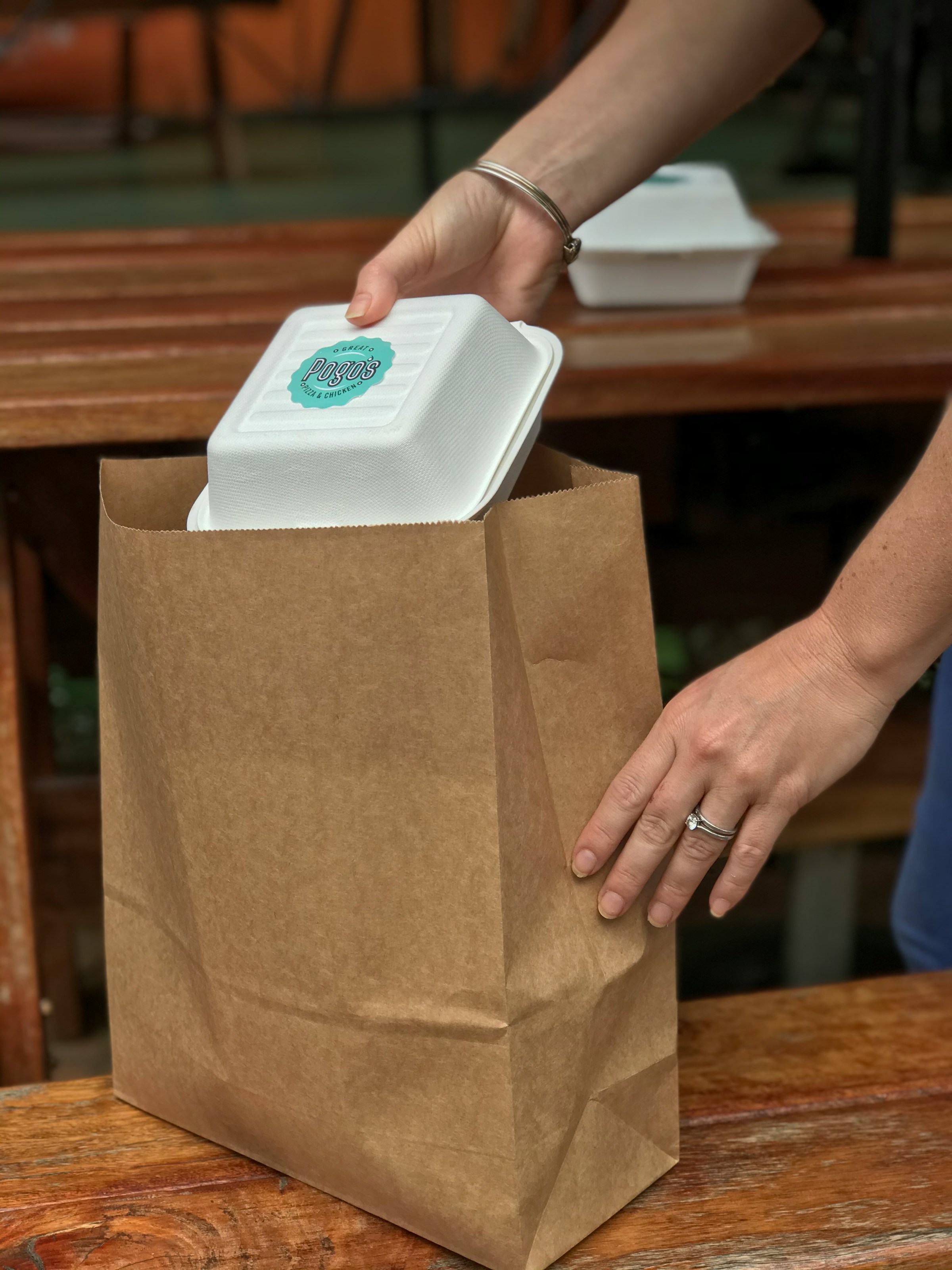 A person packing takeout into a brown bag | Source: Unsplash